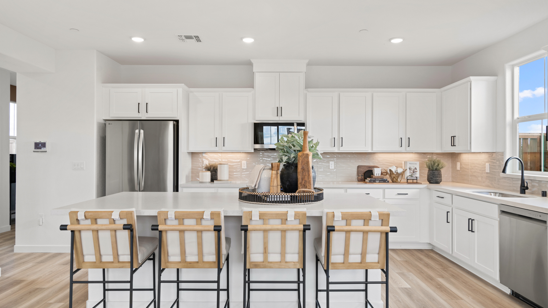 A kitchen with white cabinets.