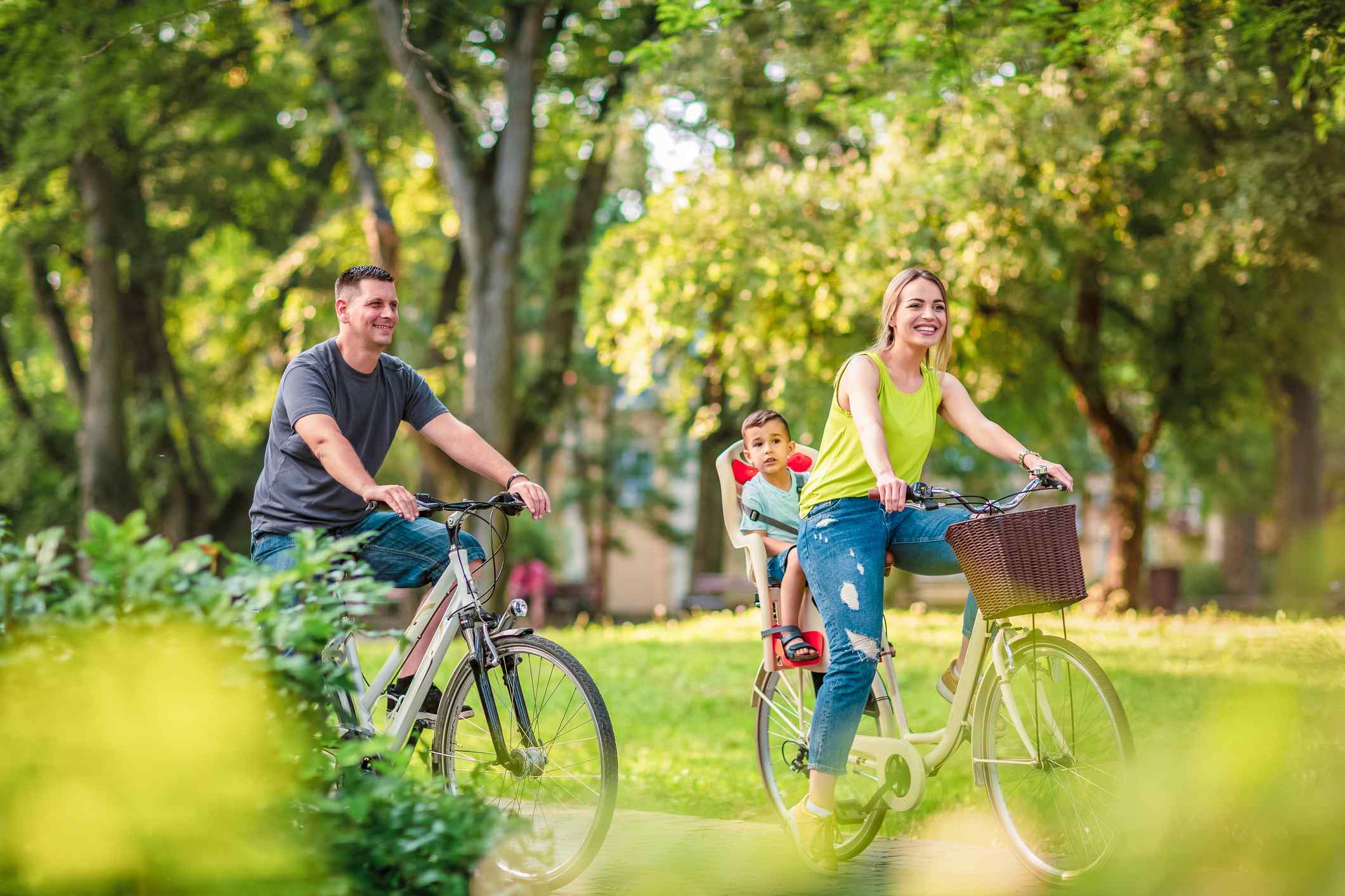 A family riding bikes in the park.