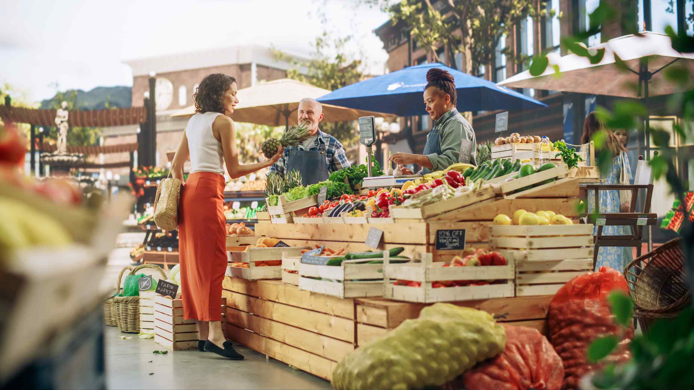 A person standing next to a fruit stand.