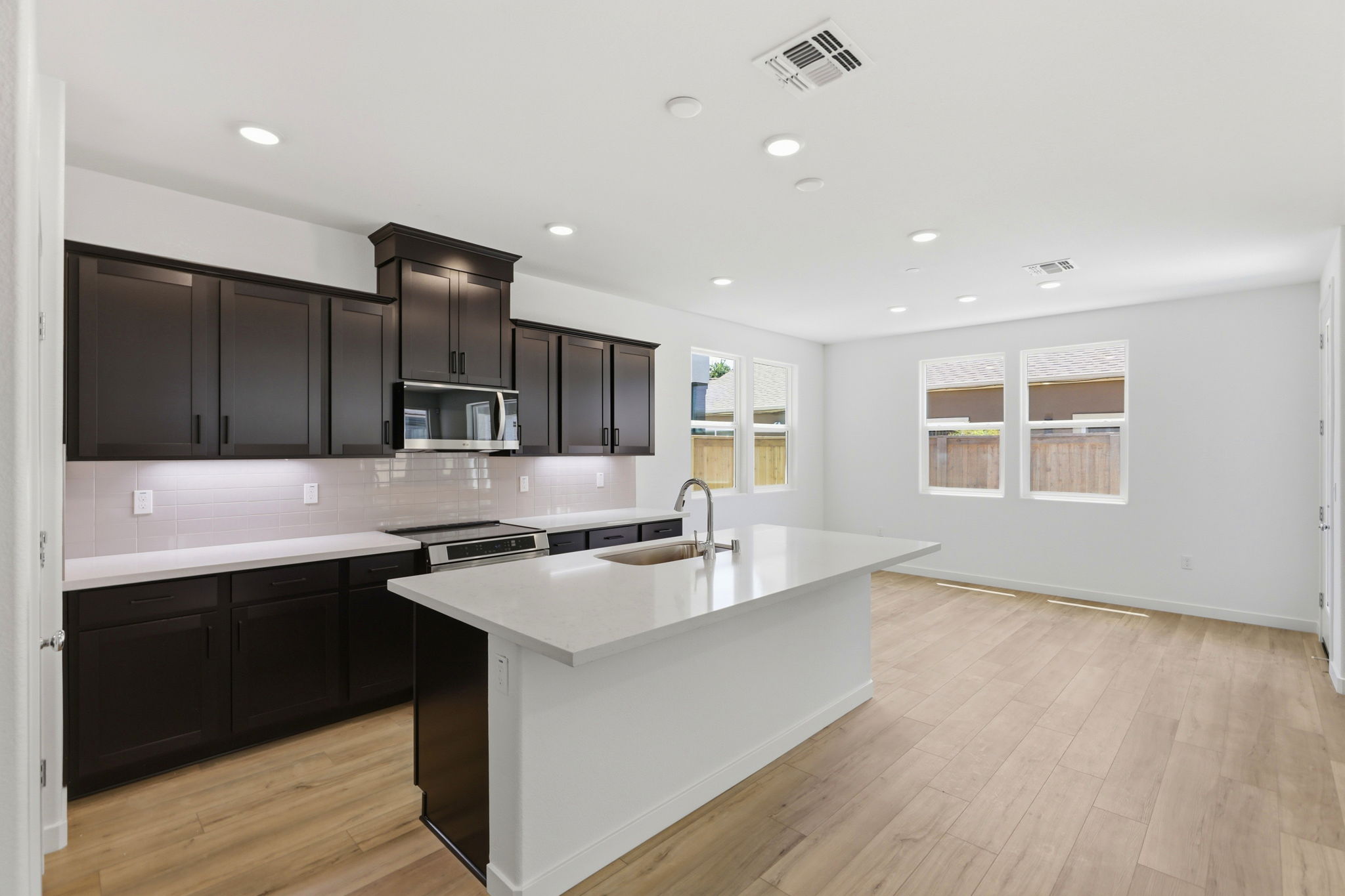 A kitchen with black cabinets.