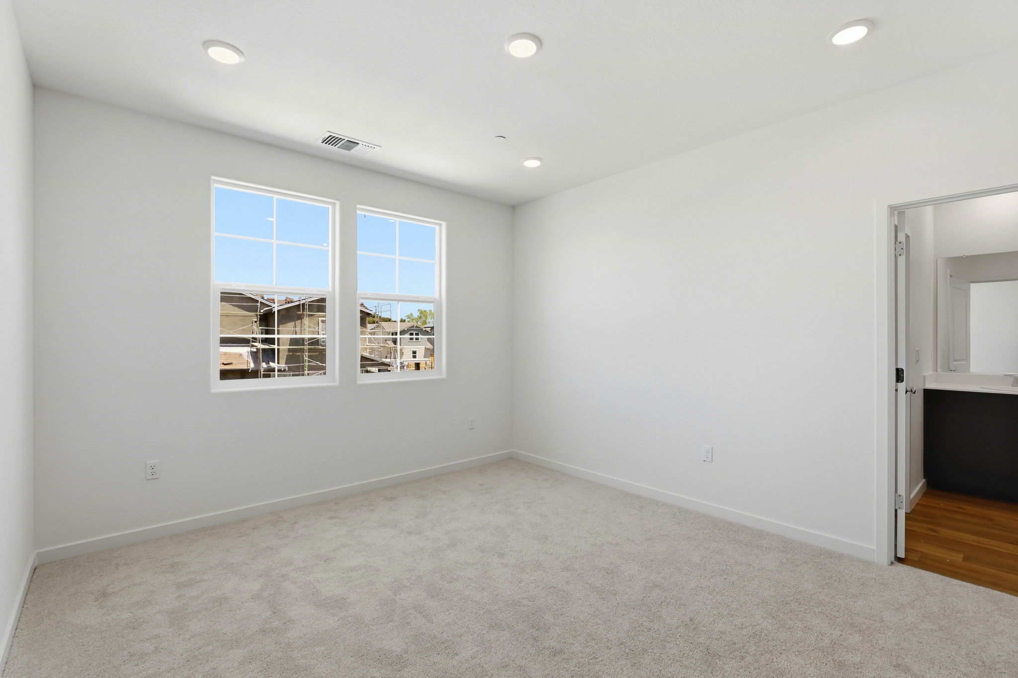 A room with a window and a door.