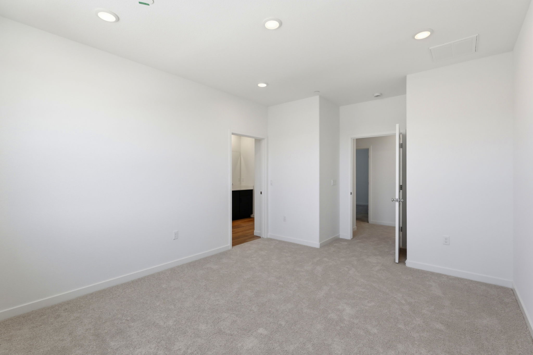 A hallway with white walls.