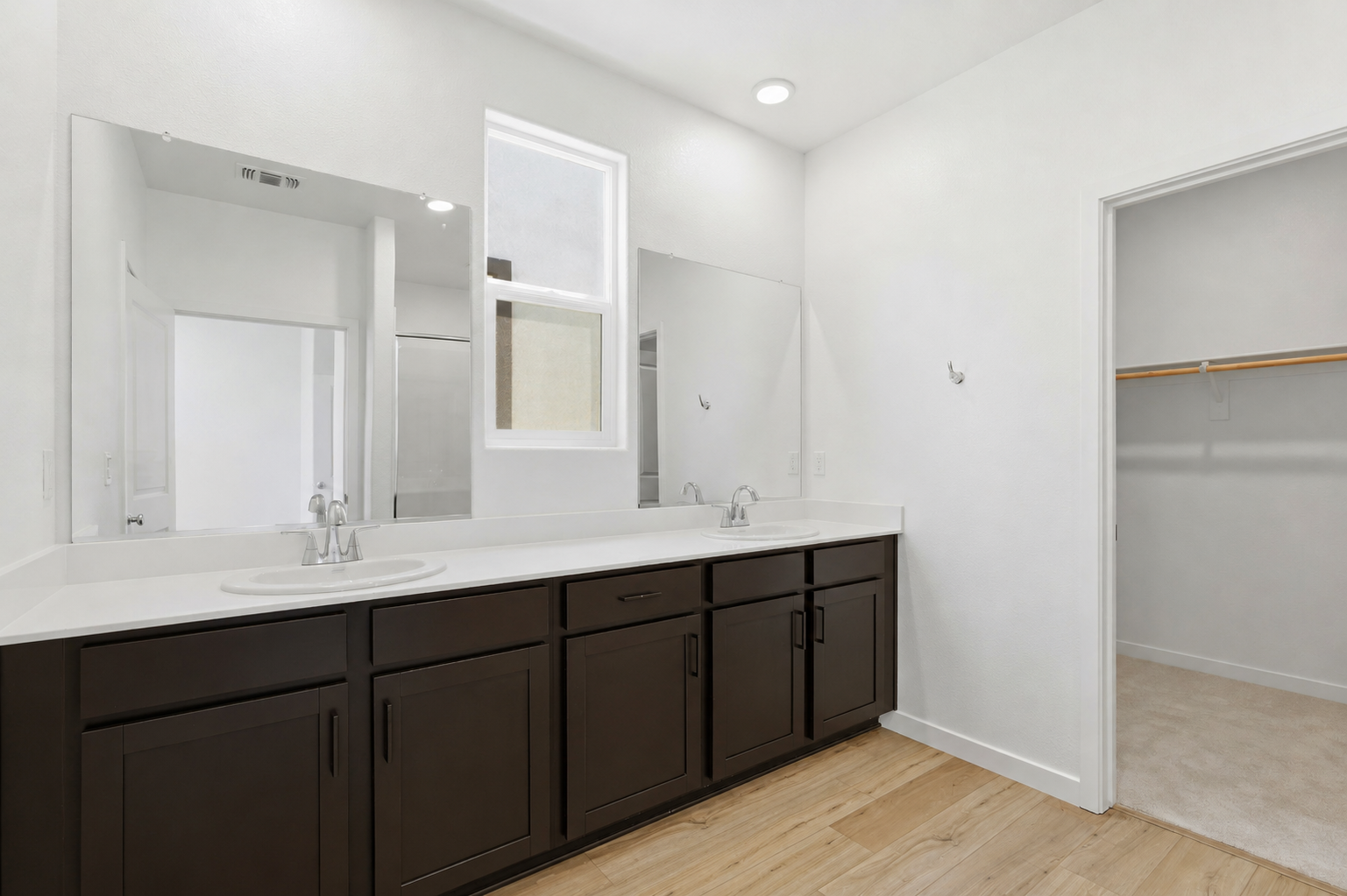 A bathroom with a large mirror.