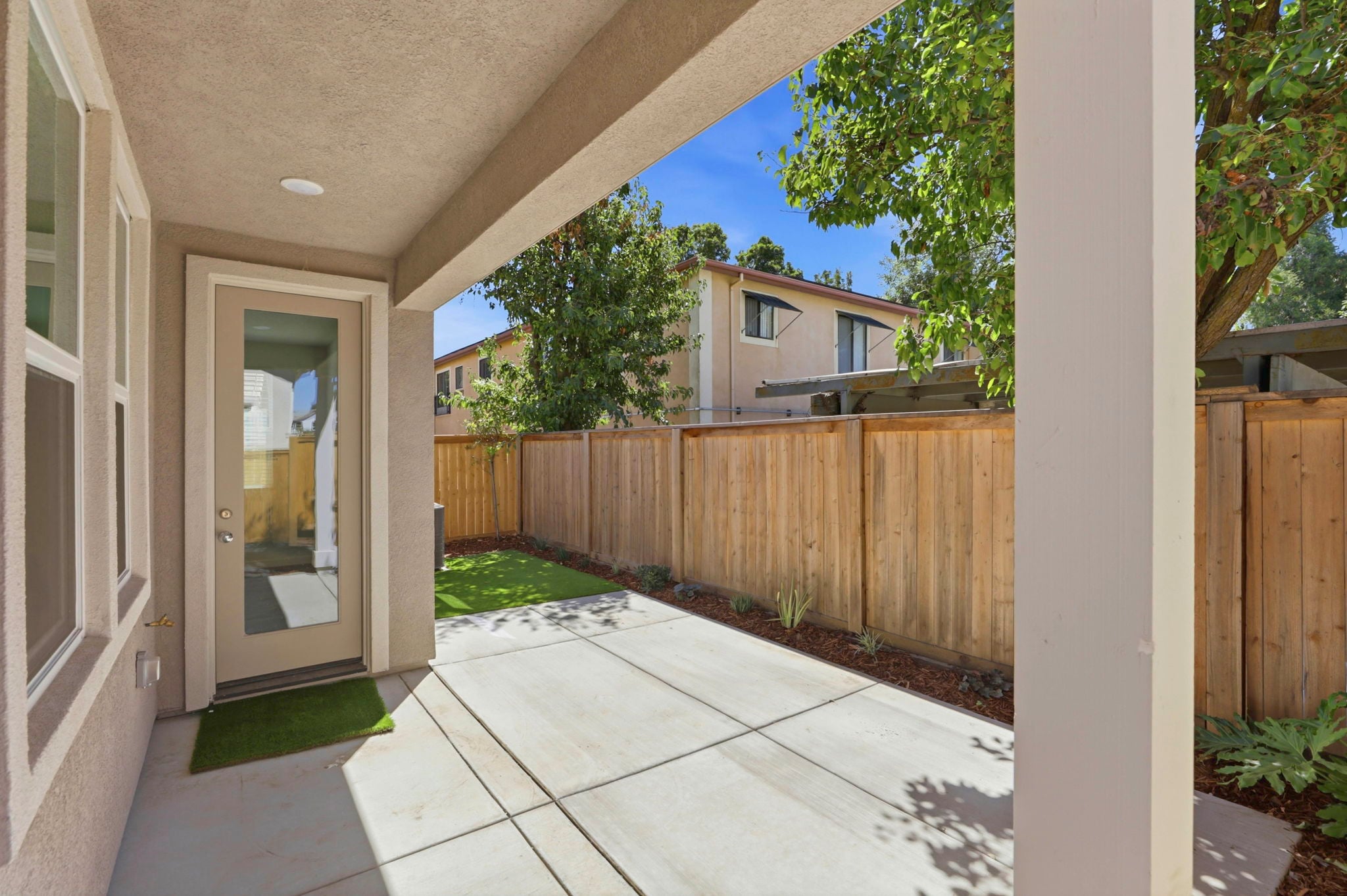 A house with a fence and a wood gate.
