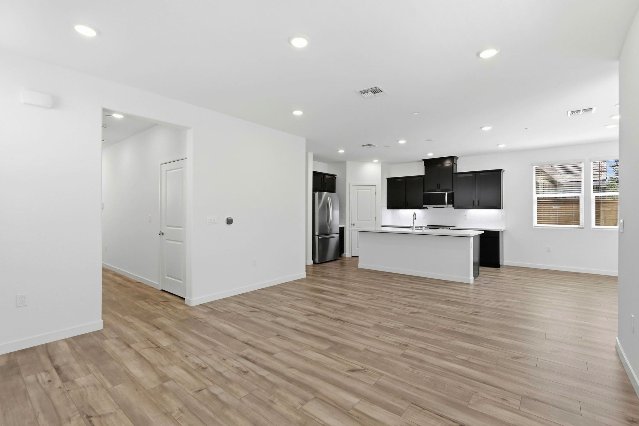A room with white walls and a wood floor.