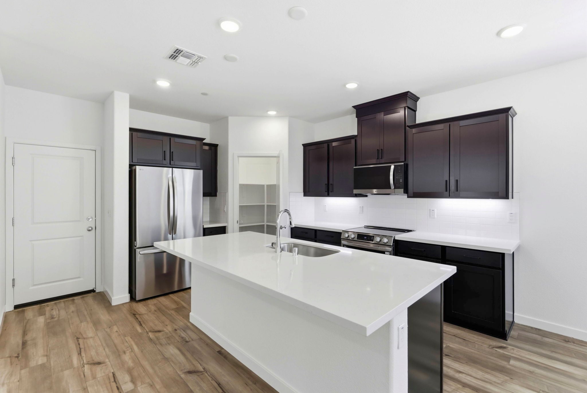 A kitchen with black cabinets.