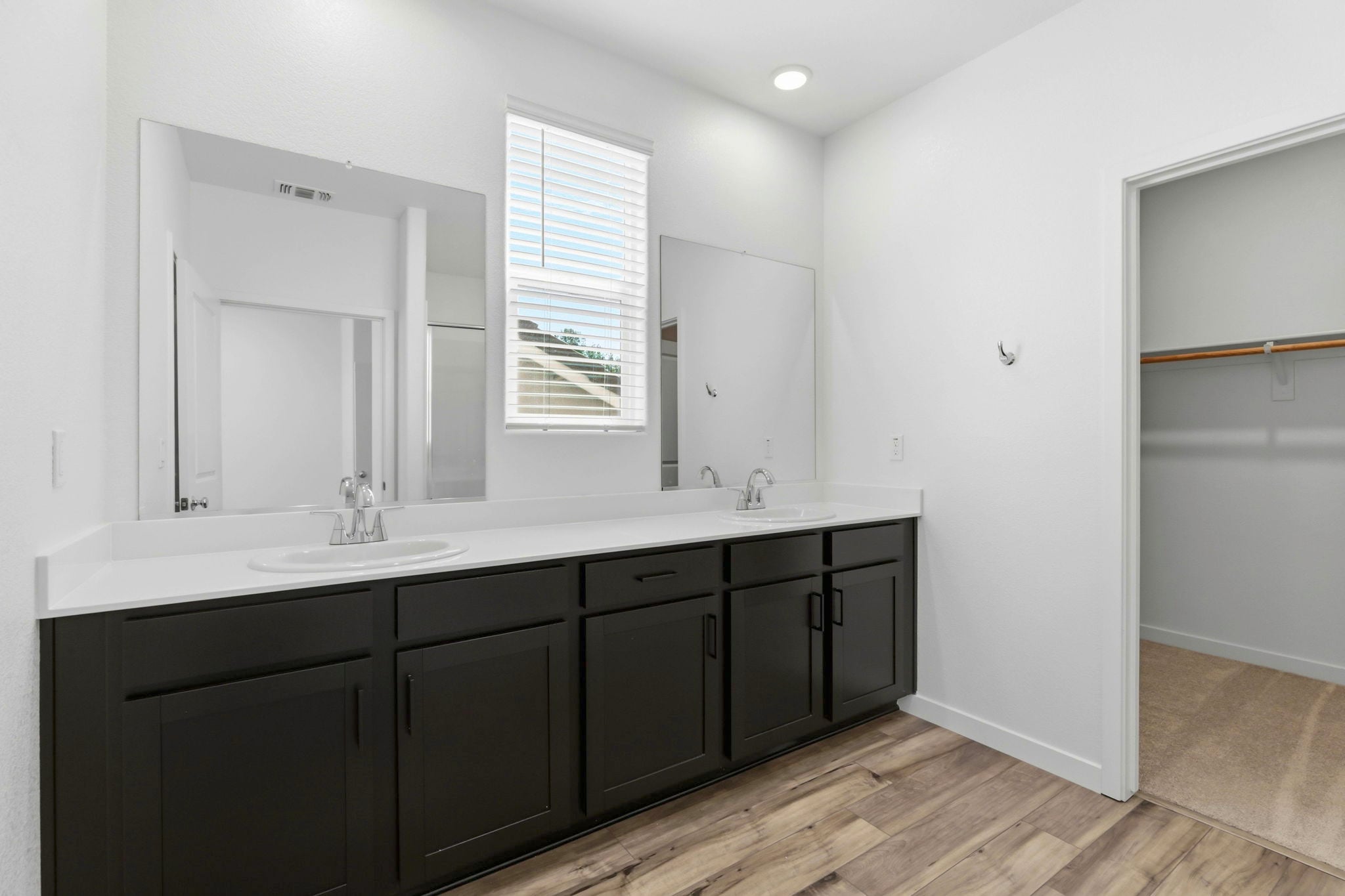 A bathroom with a large mirror.