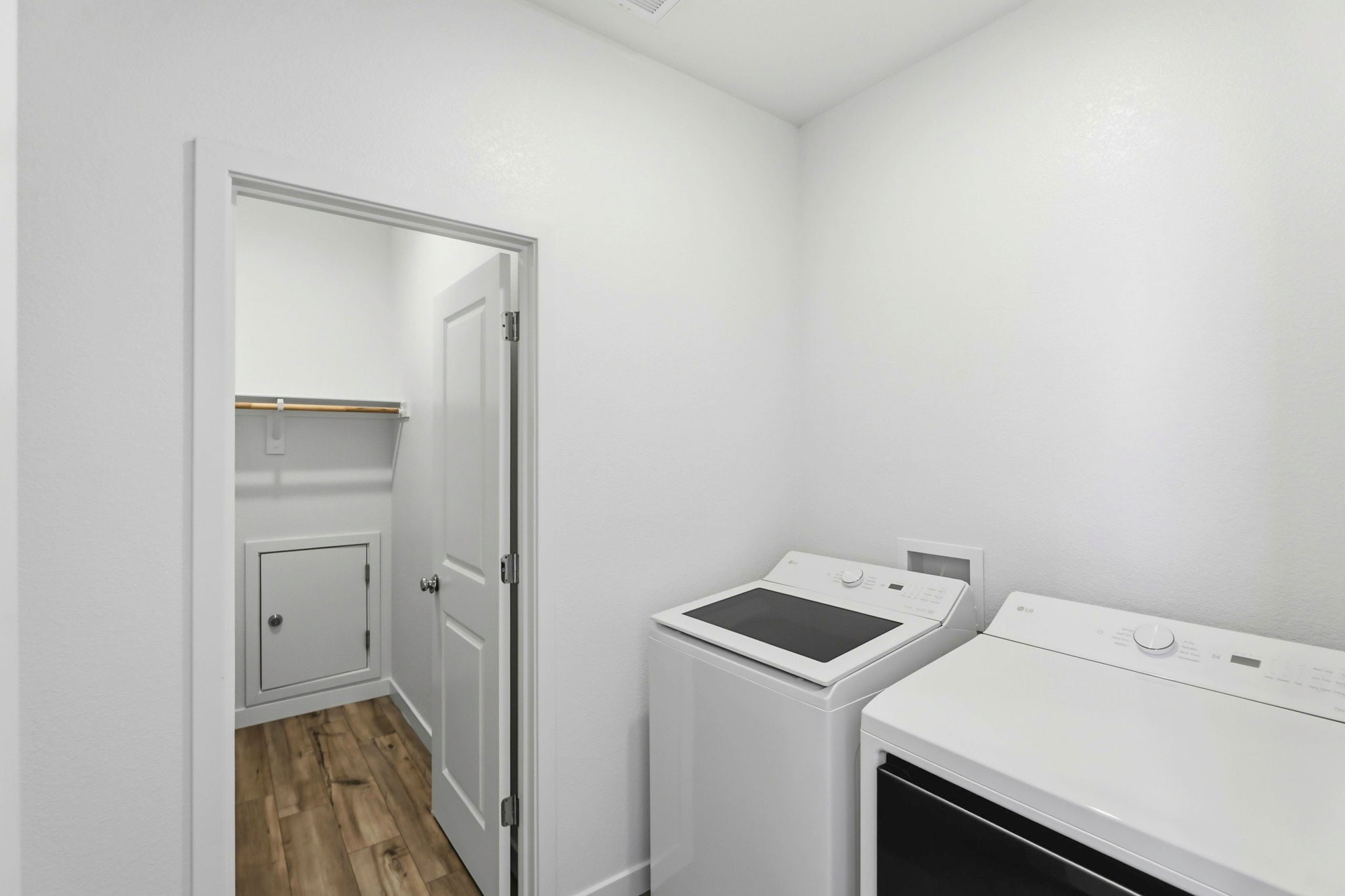 A room with a white wall and a white cabinet.