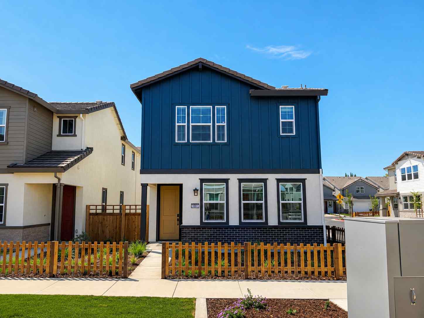 A blue house with a fence.