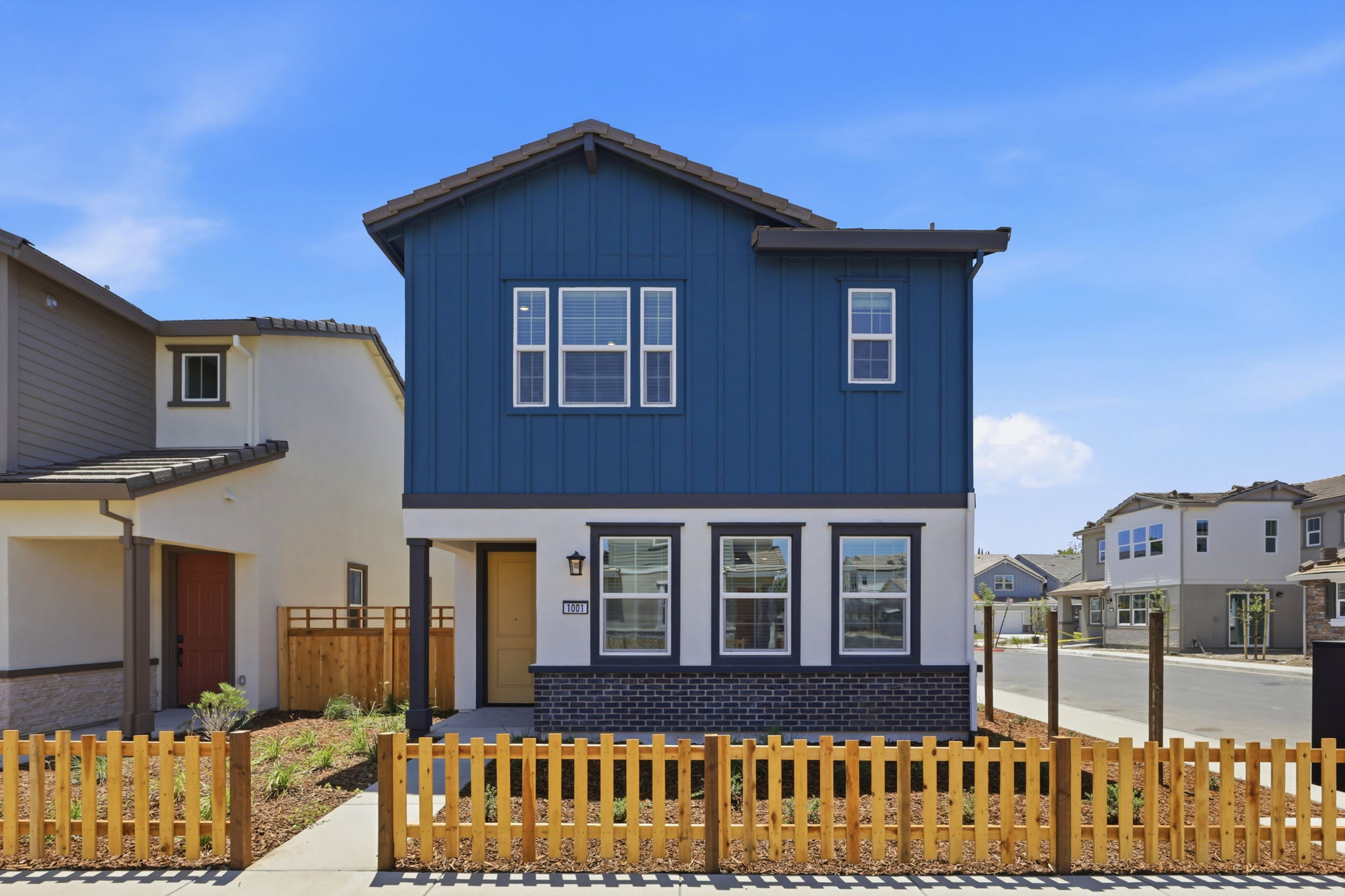 A blue house with a fence around it.