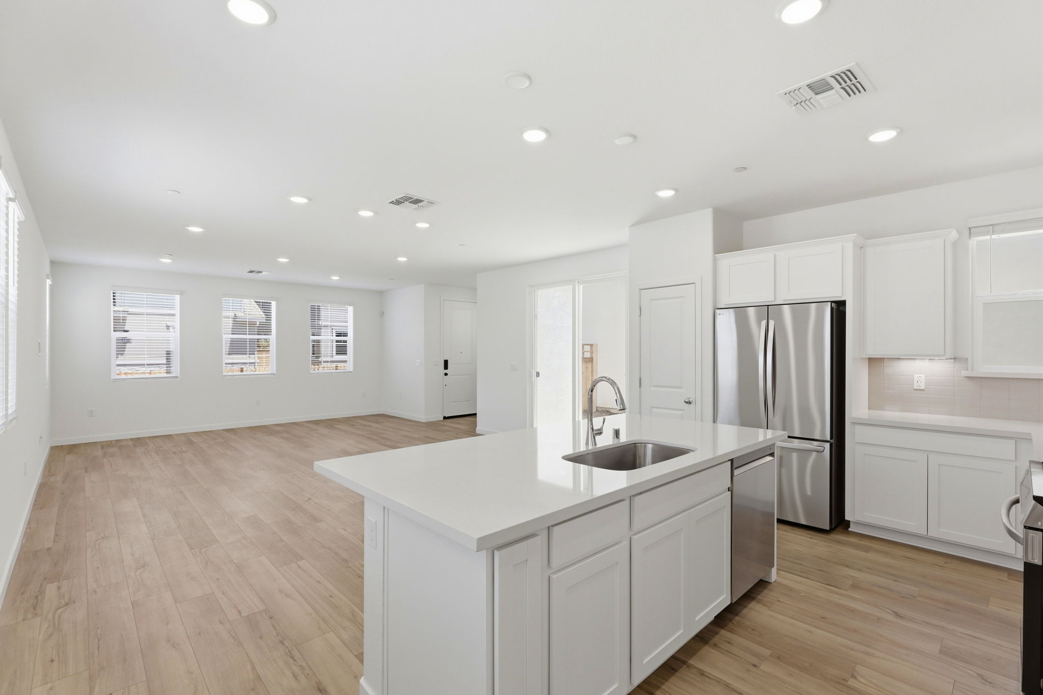A kitchen with white cabinets.
