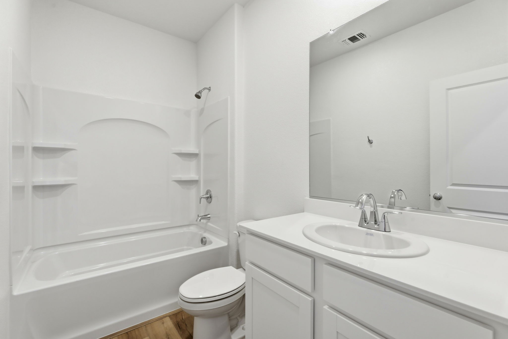 A bathroom with a tub sink and toilet.