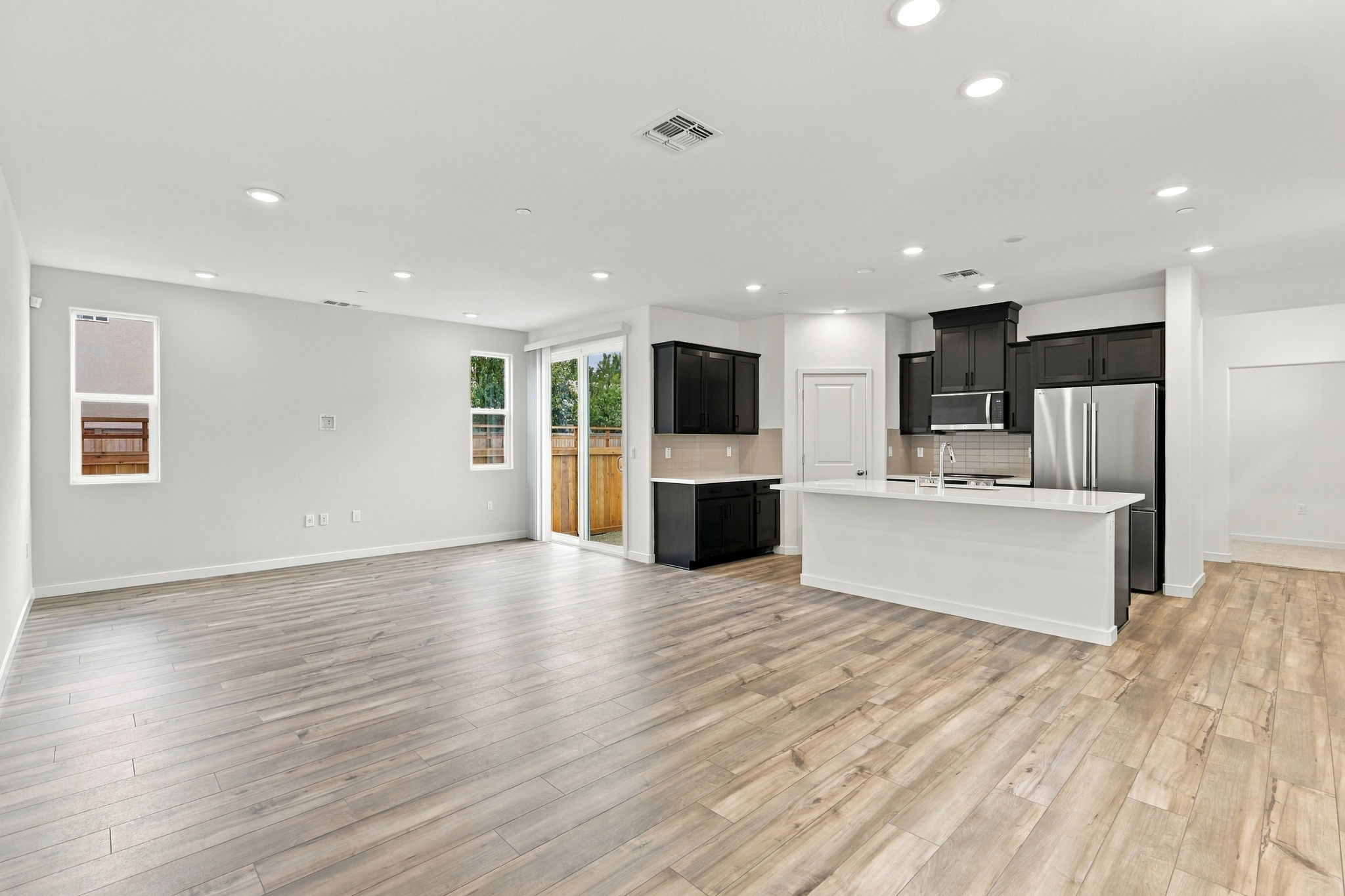 A large kitchen with a wood floor.