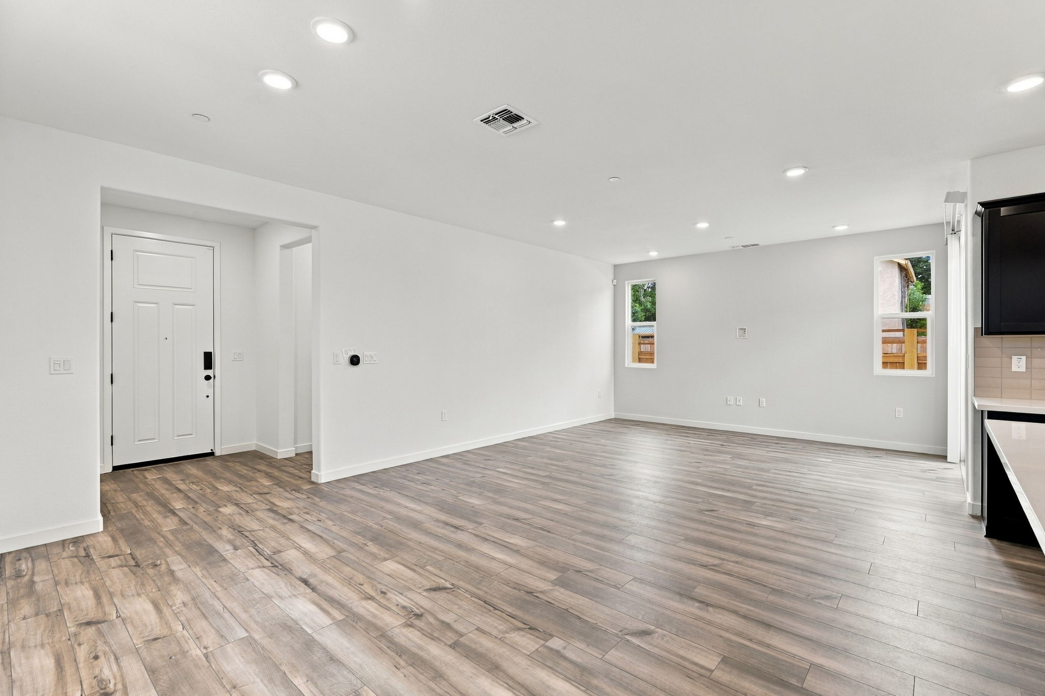 A room with white walls and a wood floor.