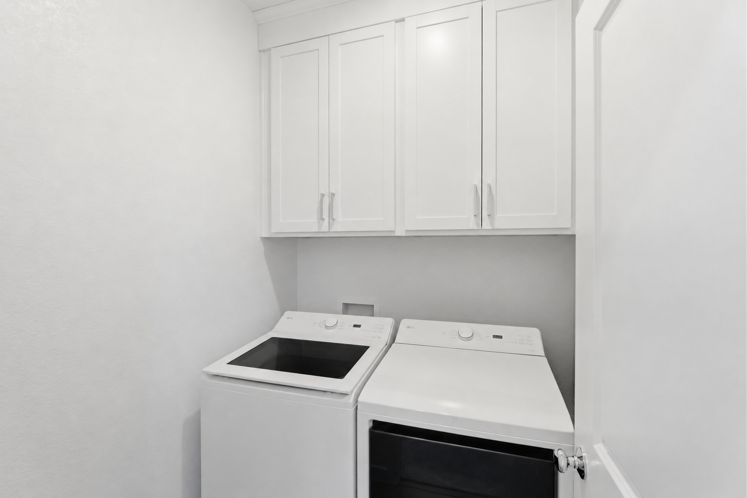 A kitchen with white cabinets.