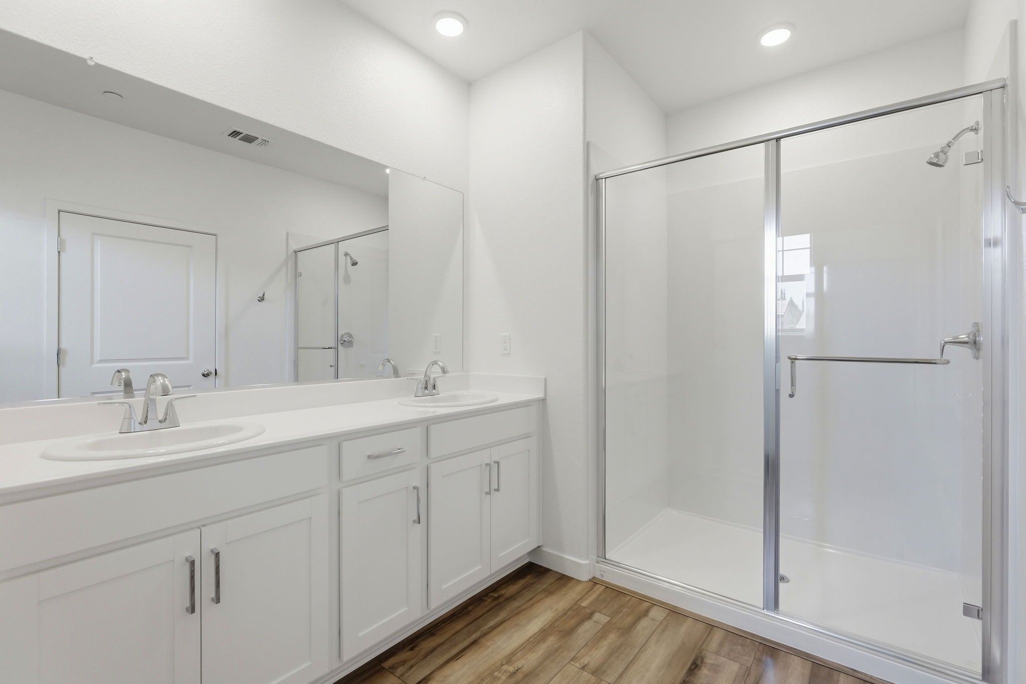 A bathroom with a shower and sink.