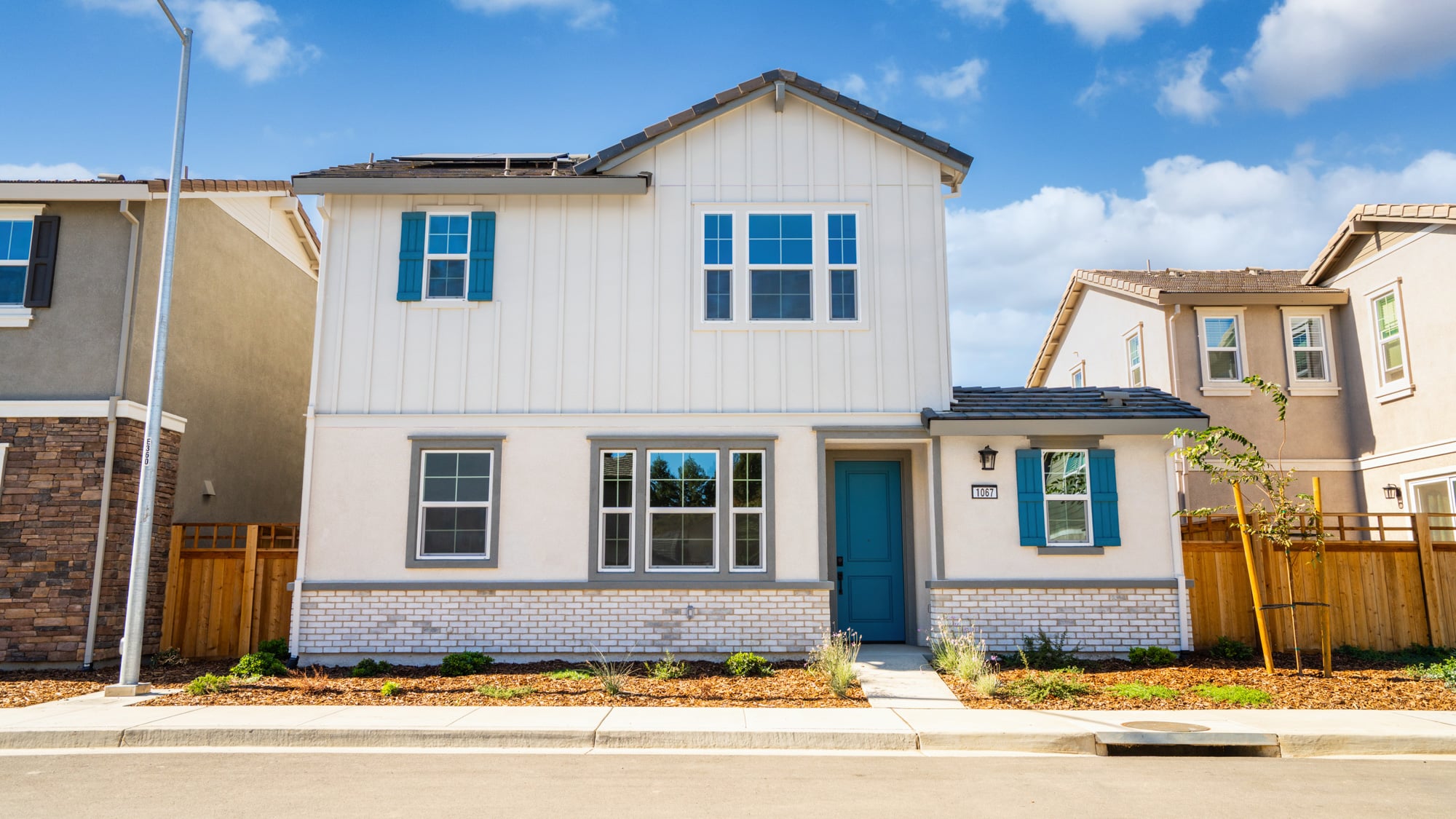 A white building with blue shutters.