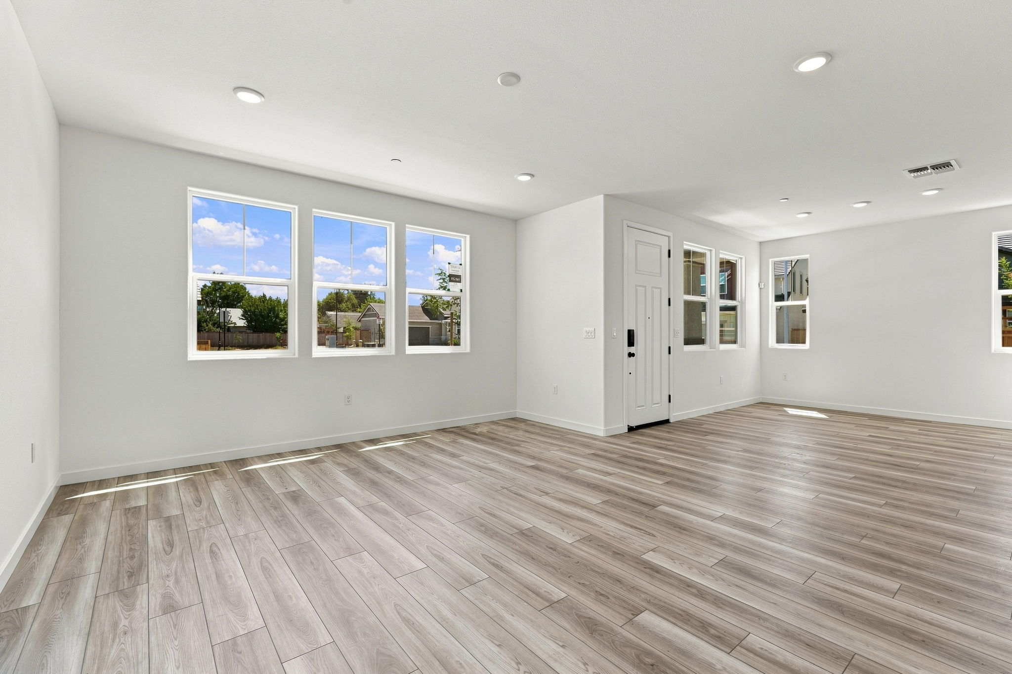 A large room with a wood floor and a wood floor.