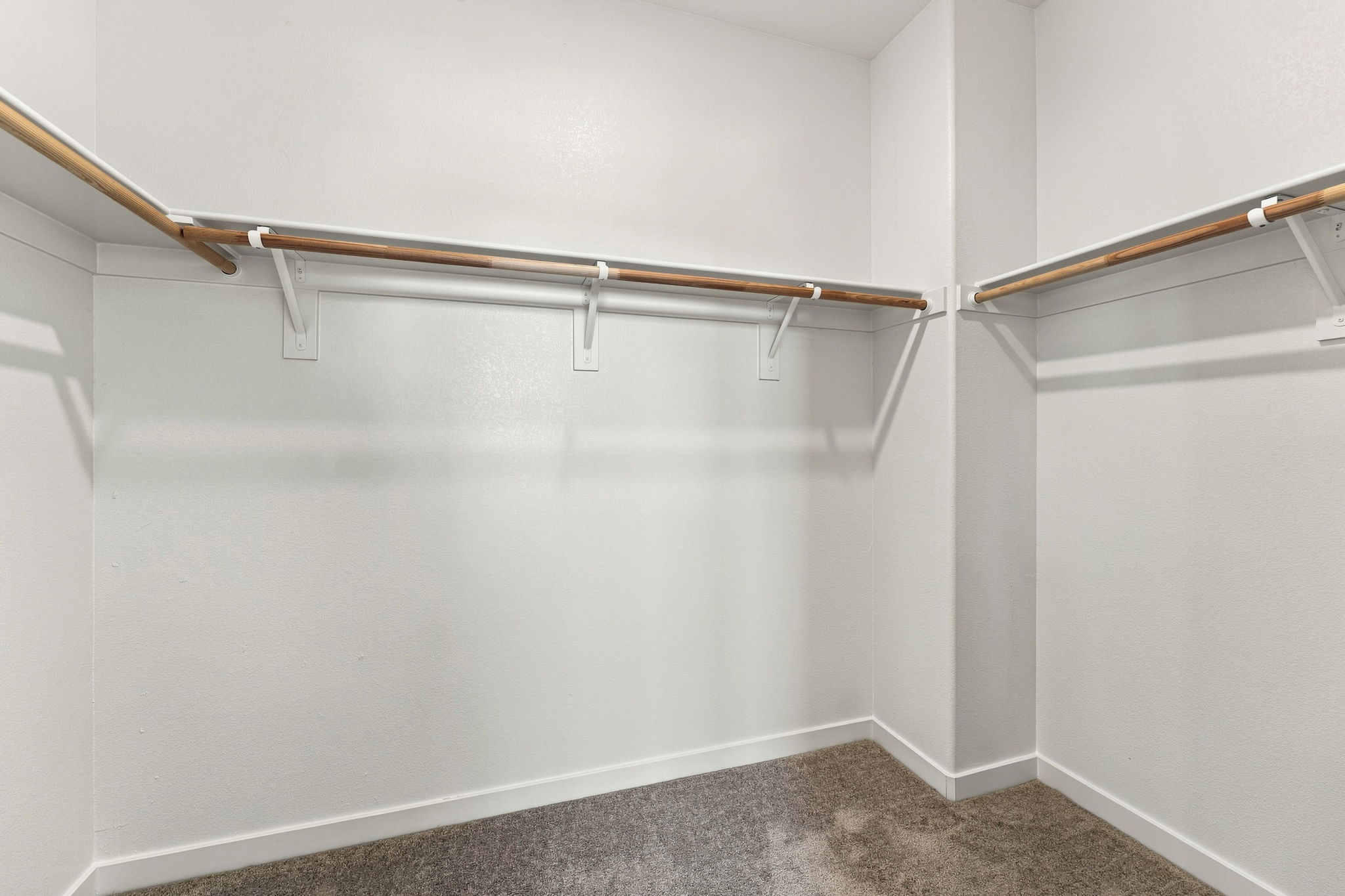 A white wall with a metal bar.
