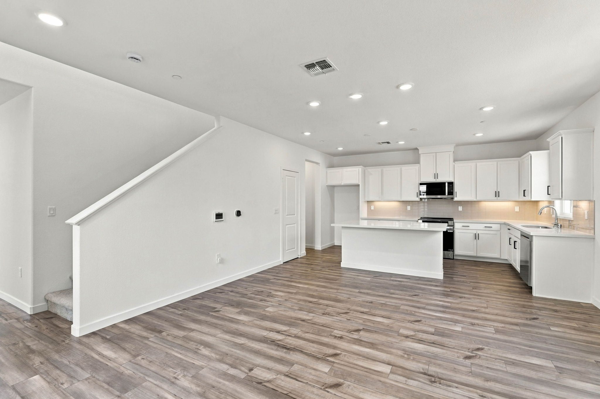 A large kitchen with white cabinets.