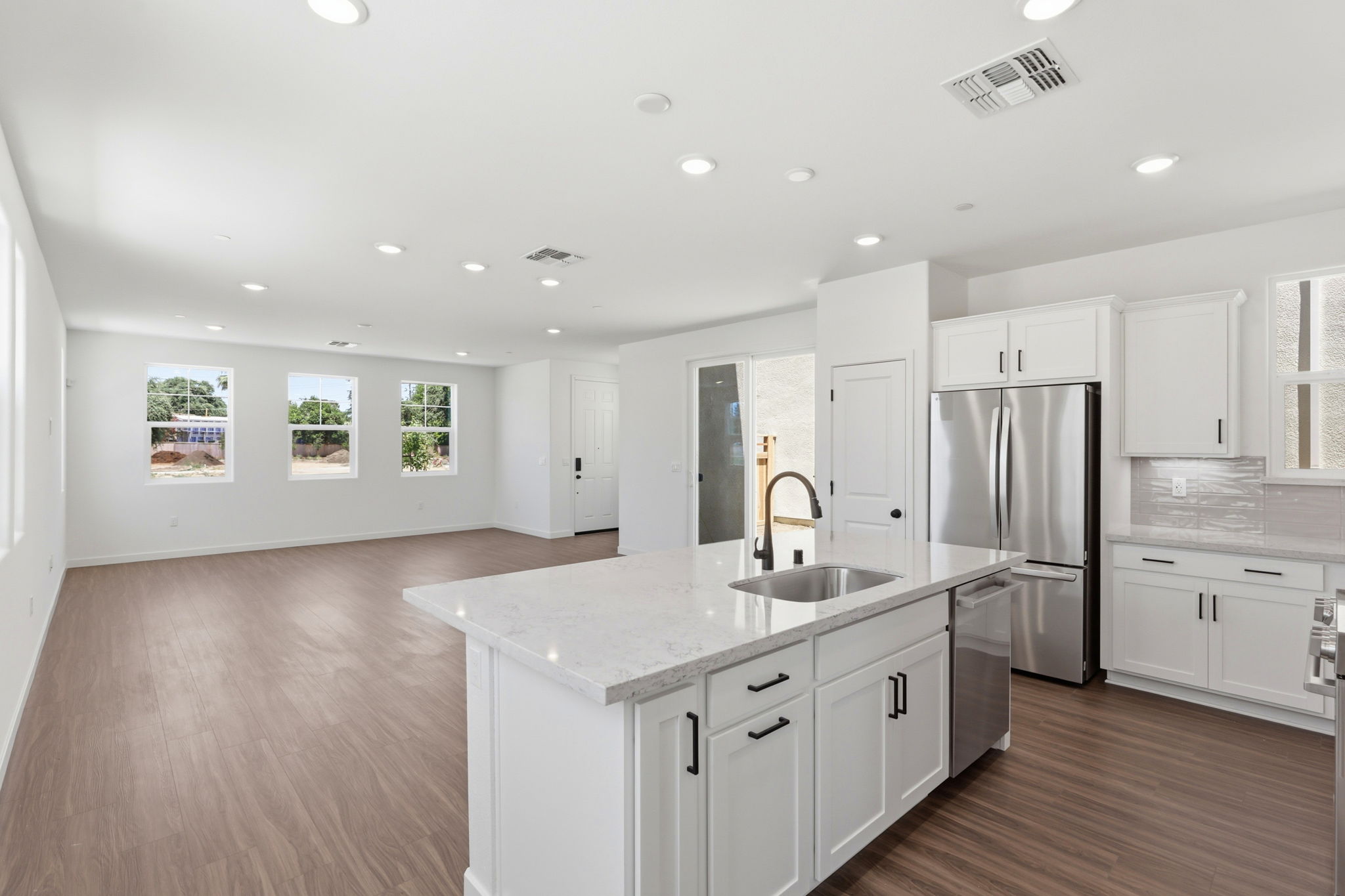 A kitchen with white cabinets.