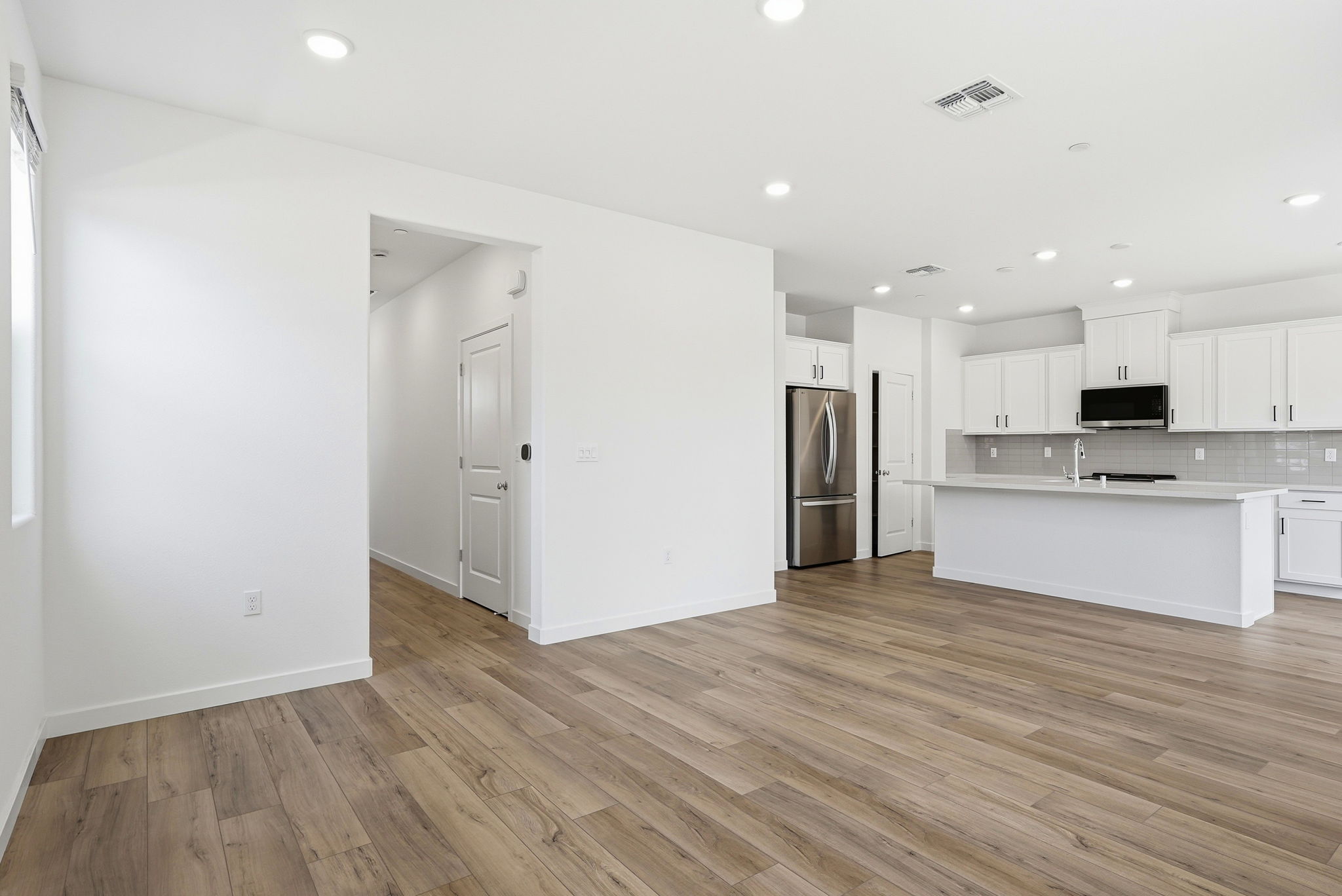 A kitchen with white cabinets.