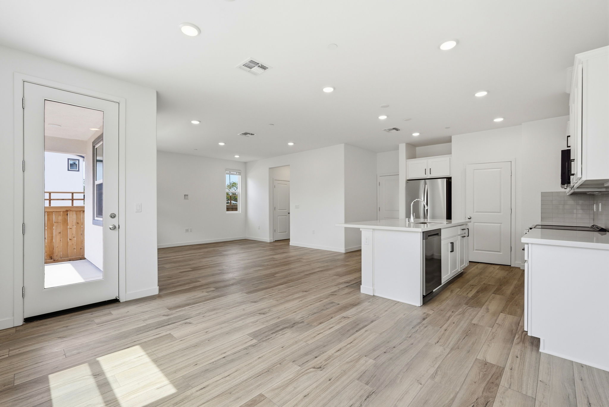 A large kitchen with white cabinets.