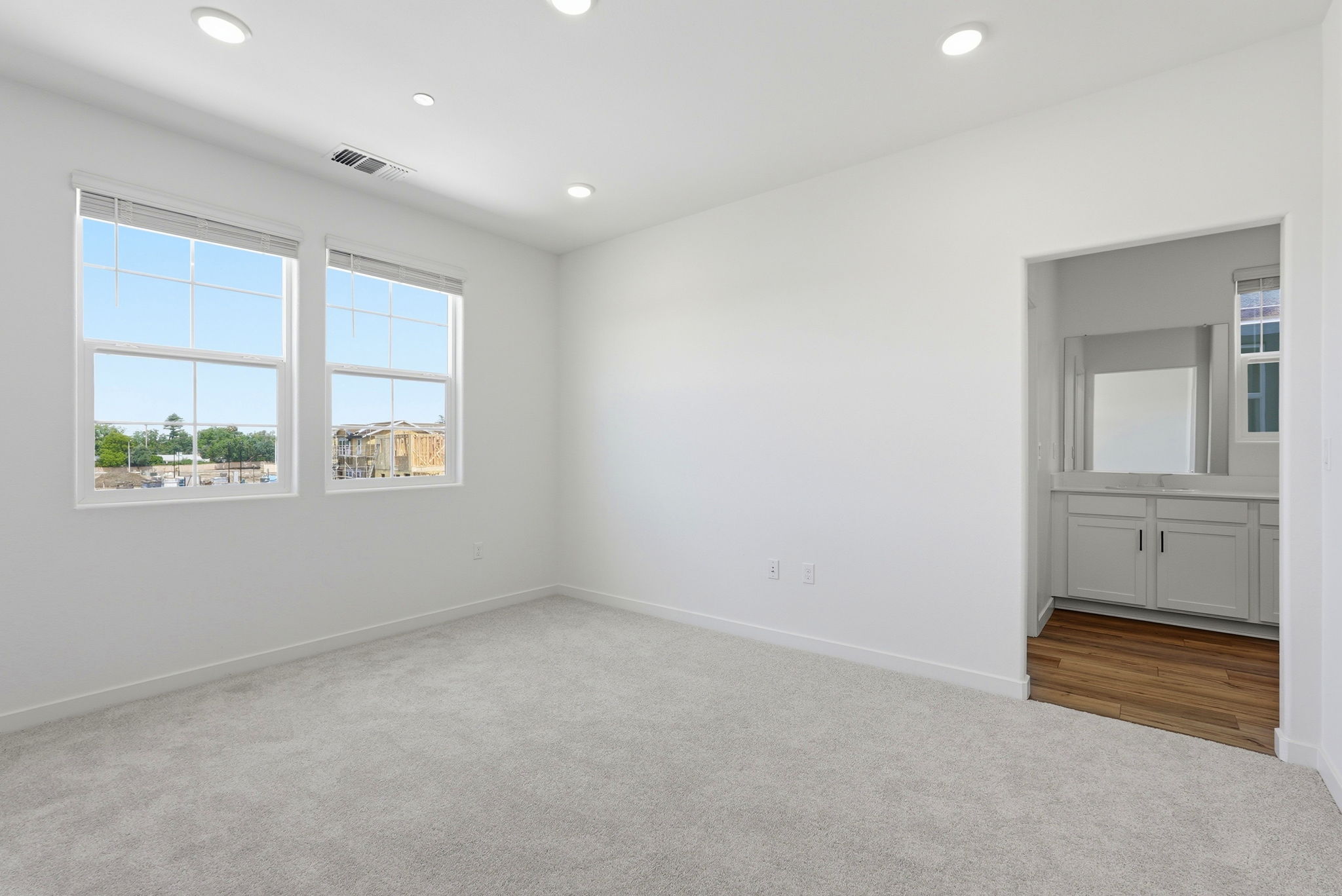 A room with white walls and windows.