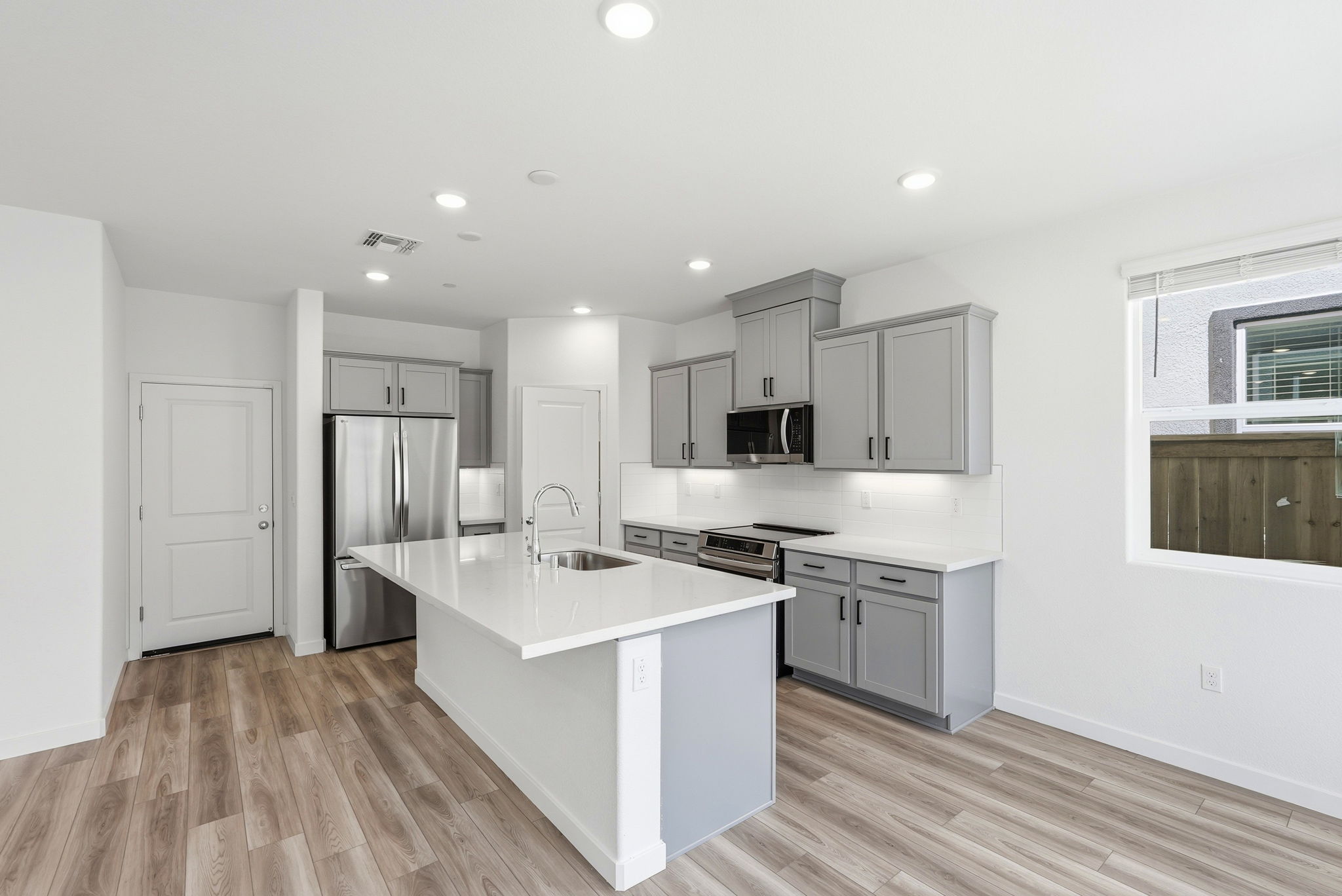 A kitchen with white cabinets.