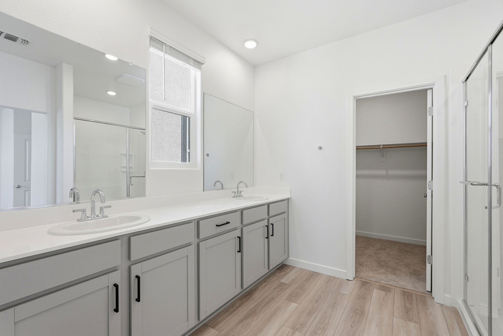 A bathroom with white cabinets.