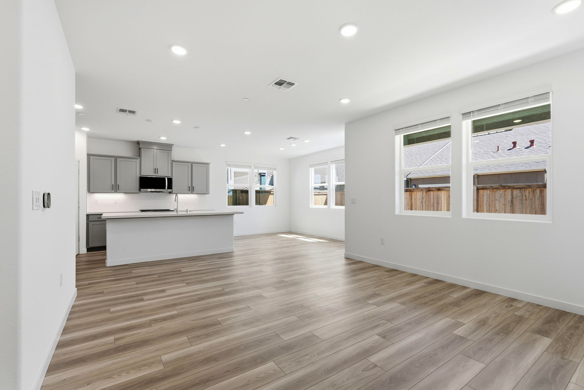 A large kitchen with white walls.