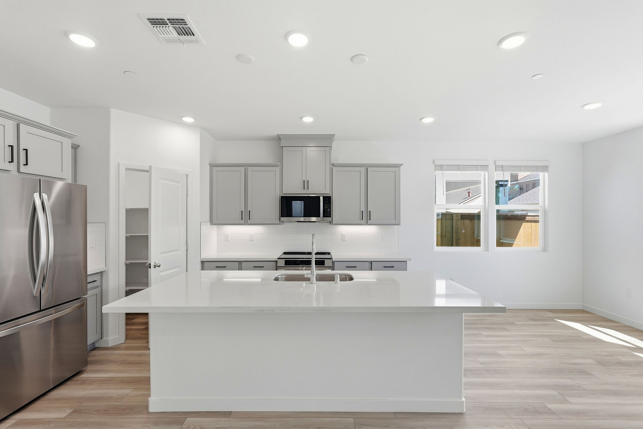 A kitchen with white cabinets.