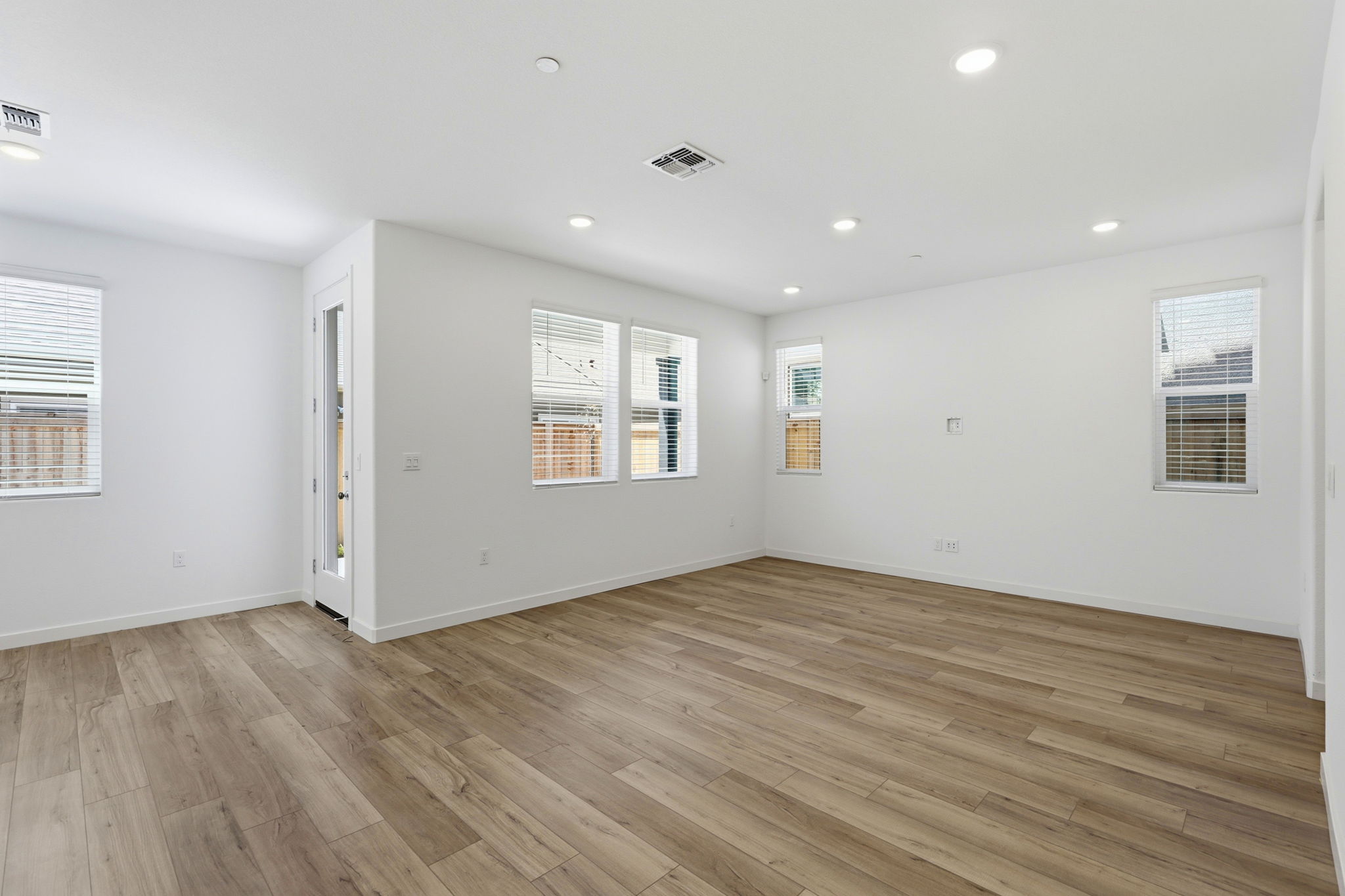 A room with a wood floor and white walls.