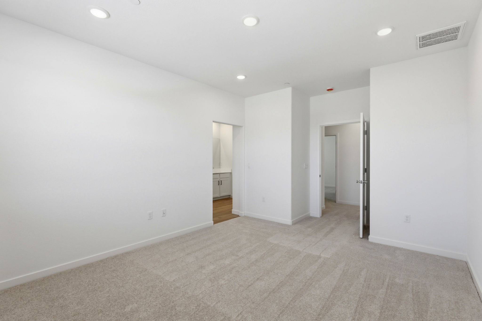 A long hallway with white walls.