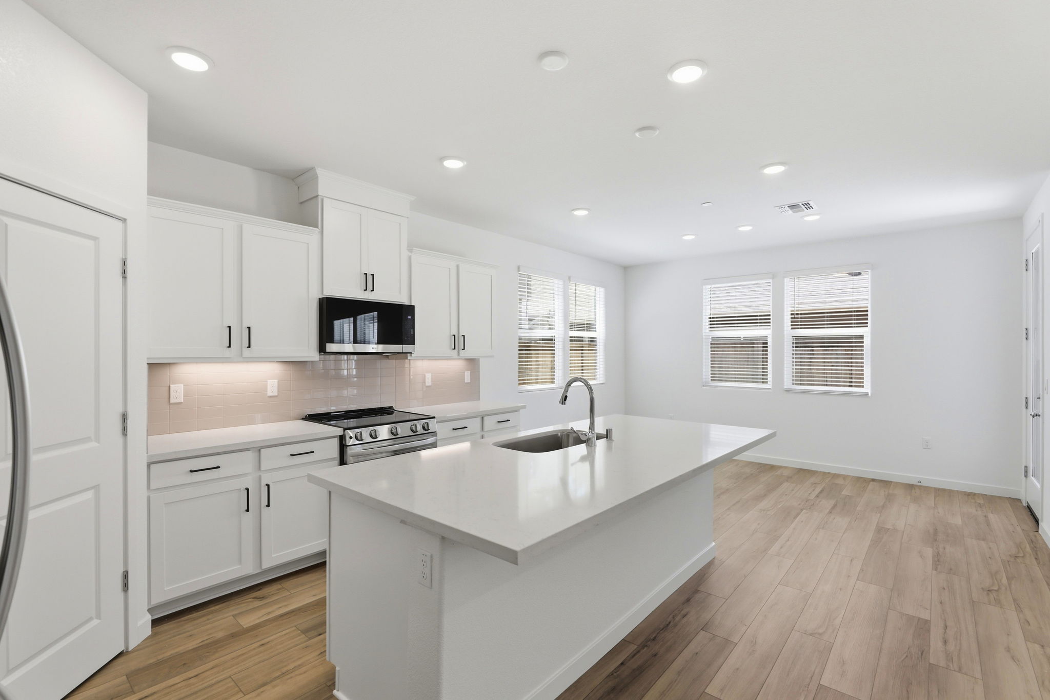 A kitchen with white cabinets.