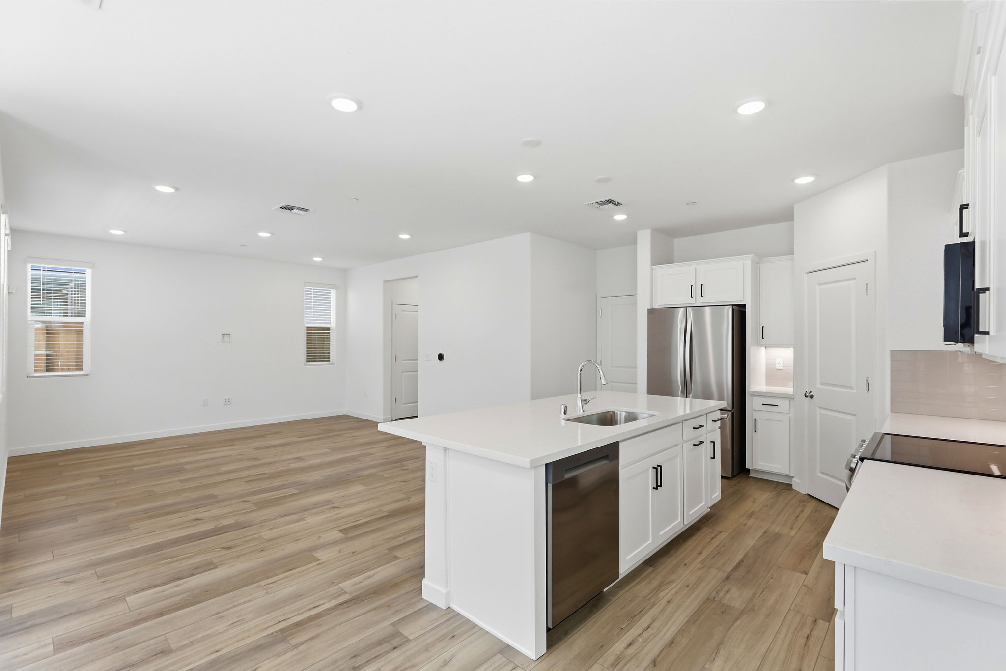 A kitchen with white cabinets.