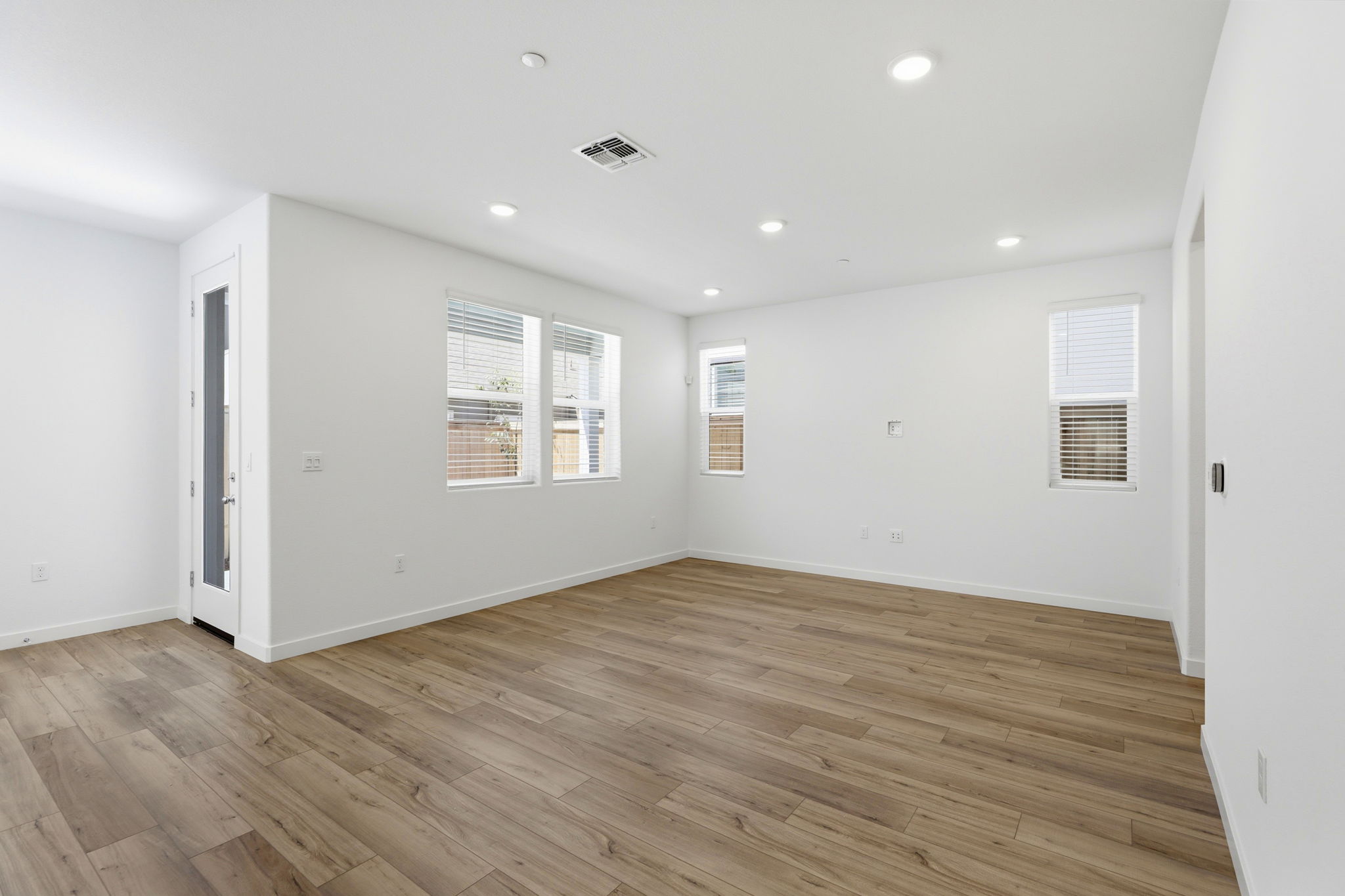 A room with a wood floor and white walls.