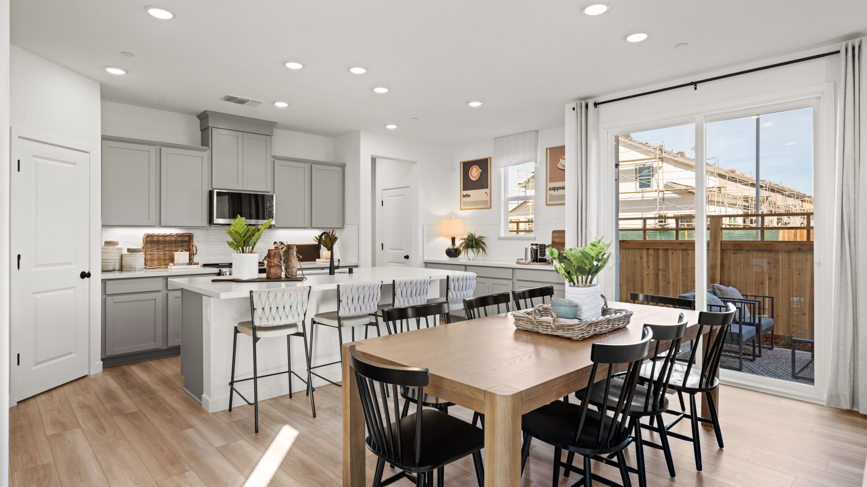 A kitchen with a dining table and chairs.