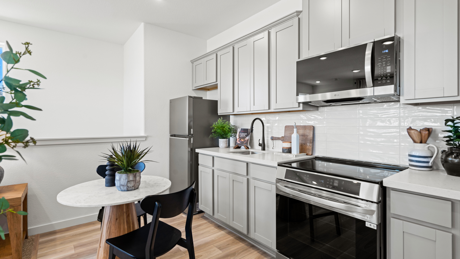 A kitchen with white cabinets.