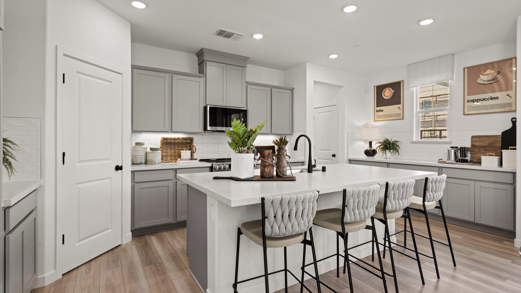 A kitchen with white cabinets.