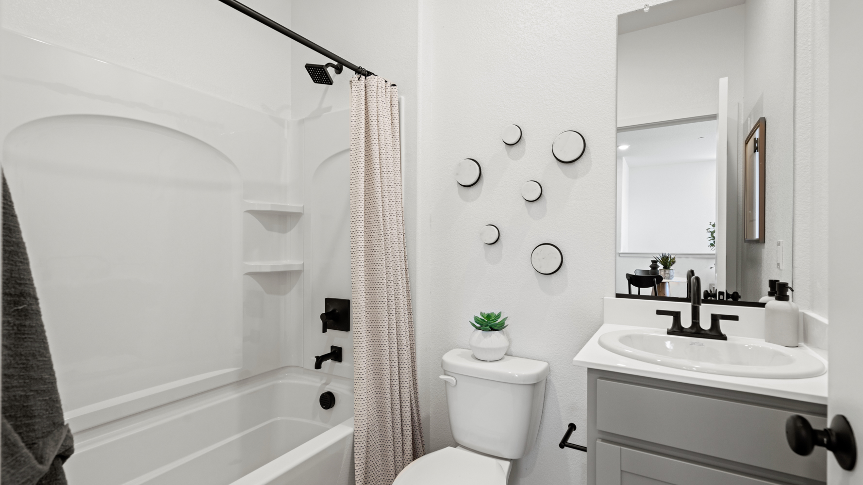 A bathroom with a bathtub sink and toilet.
