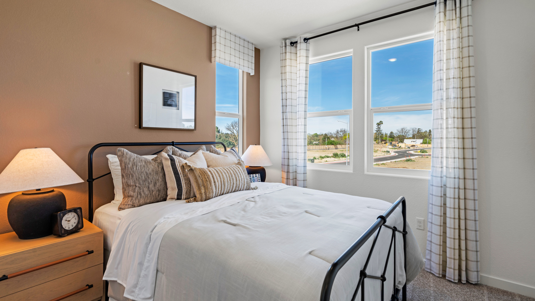 A bed with a white bed spread.