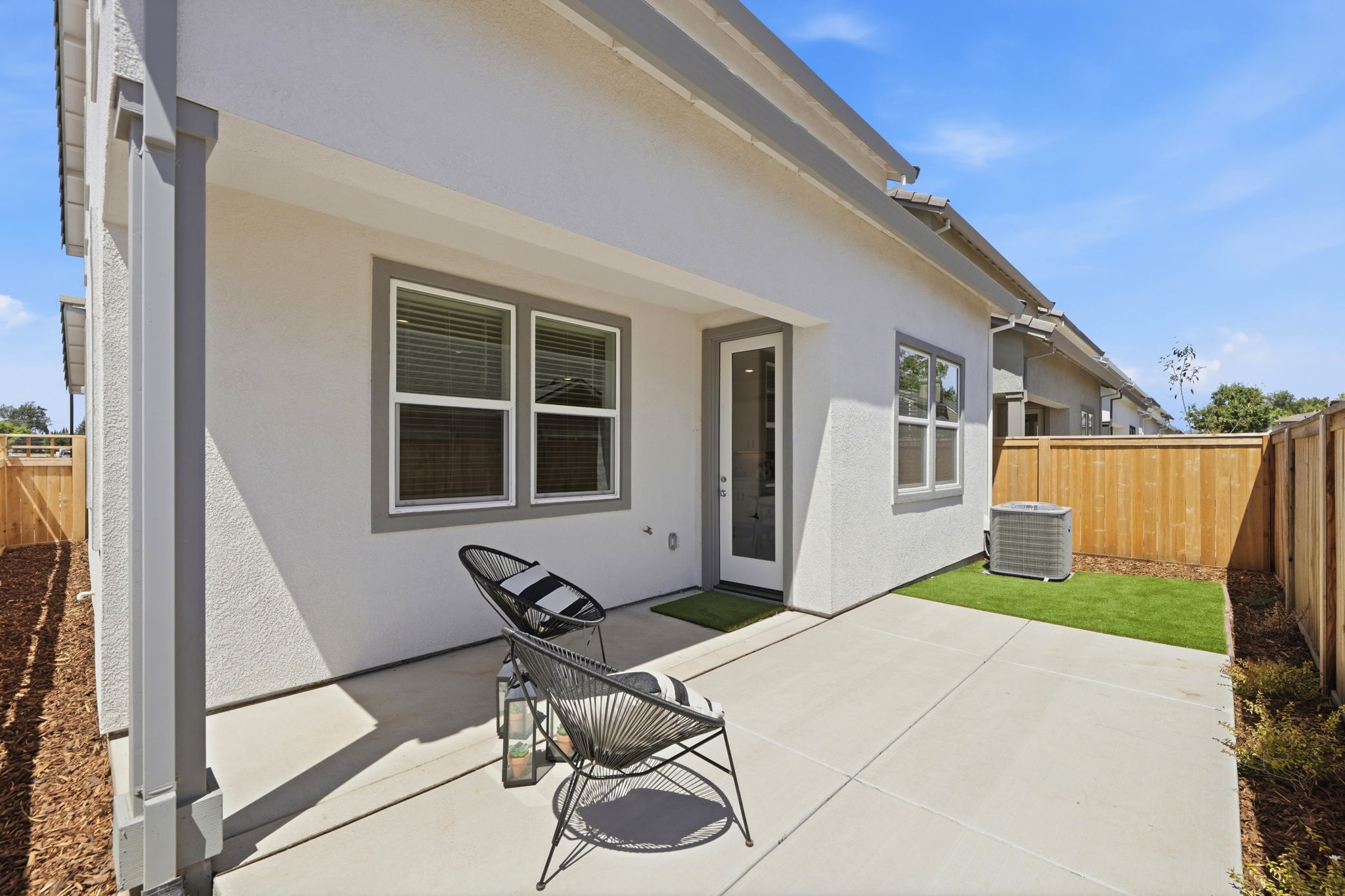 A house with a patio and a chair outside.