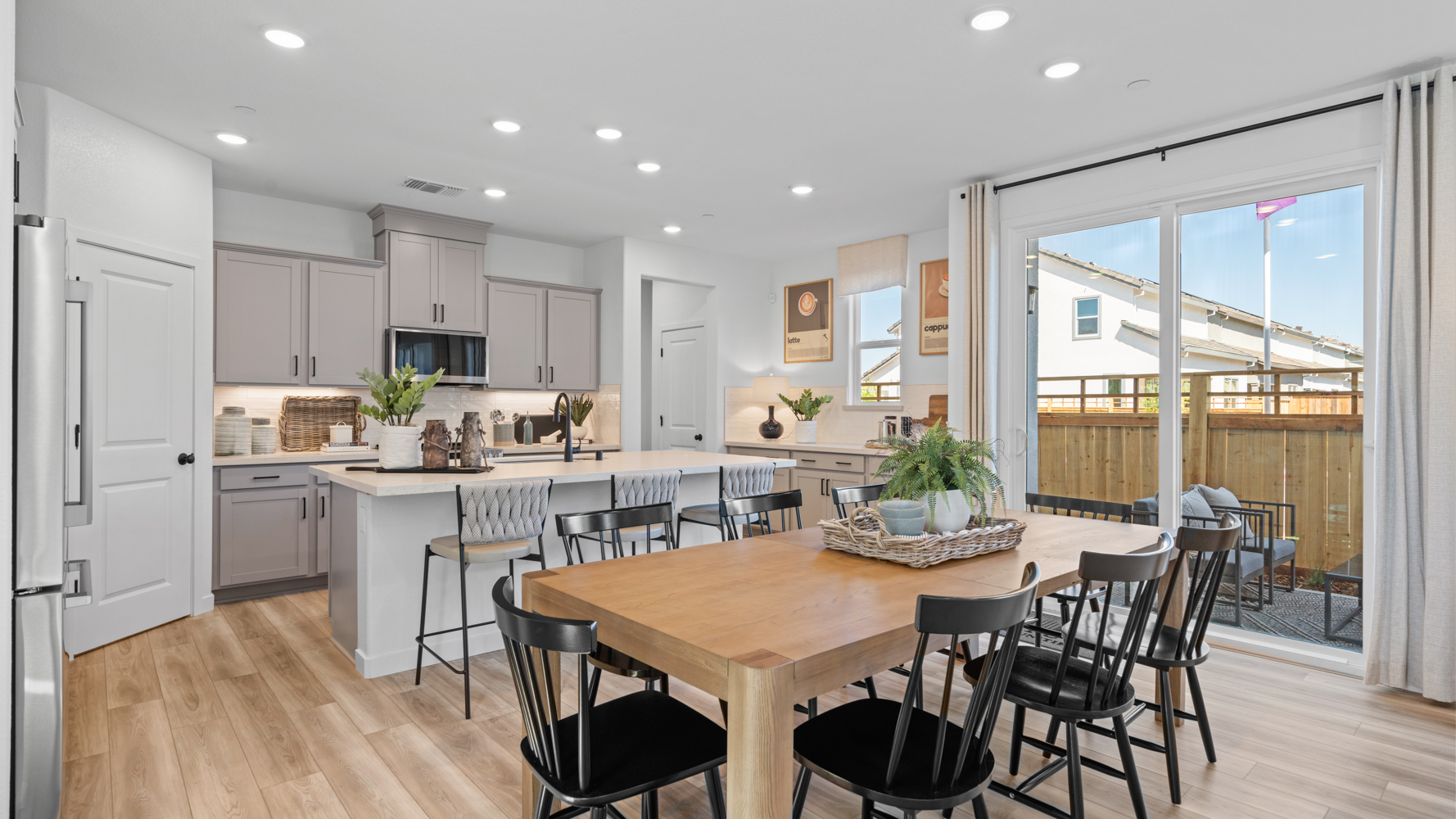 A kitchen with a dining table and chairs.
