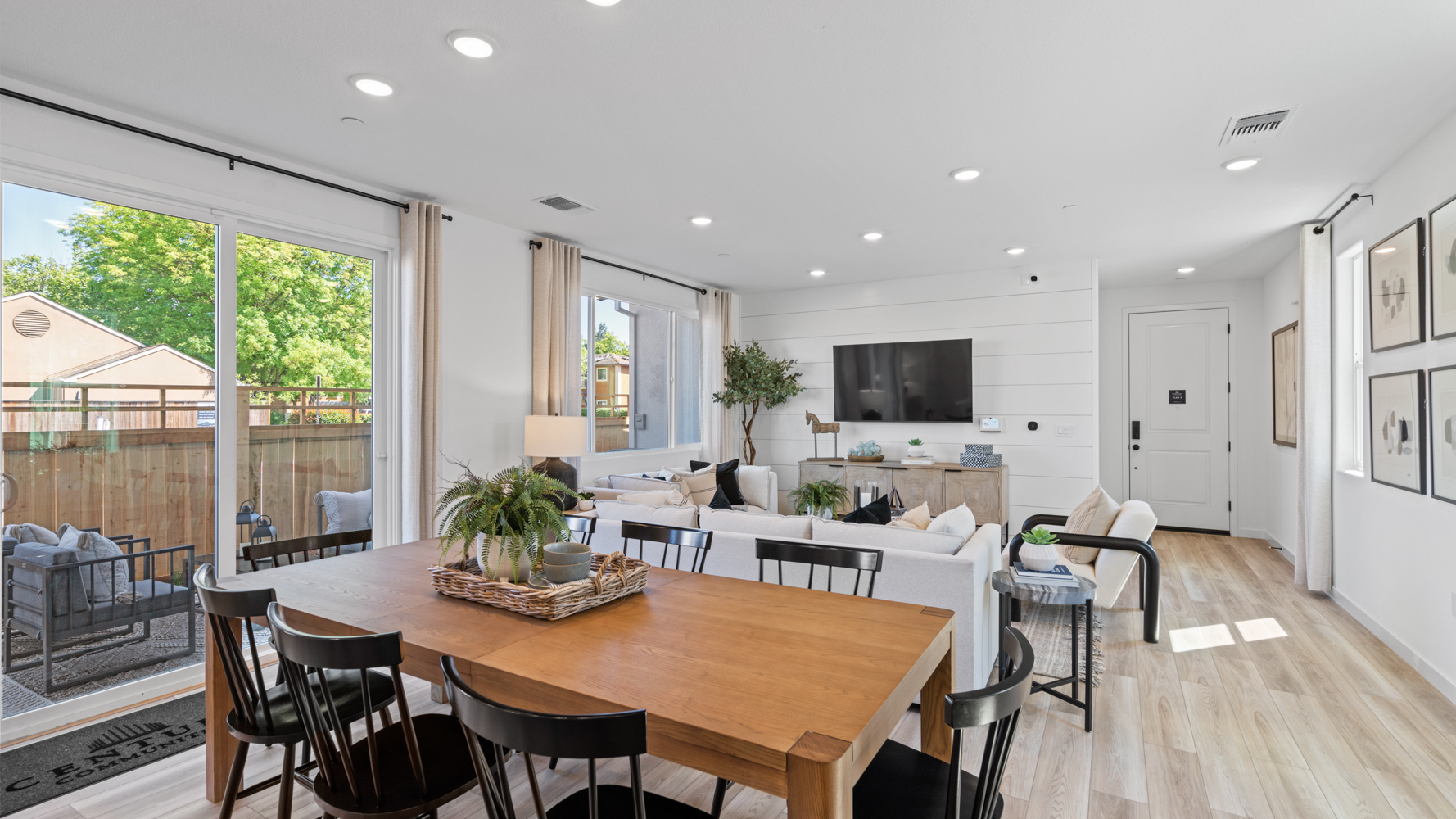 A dining room with a large table.