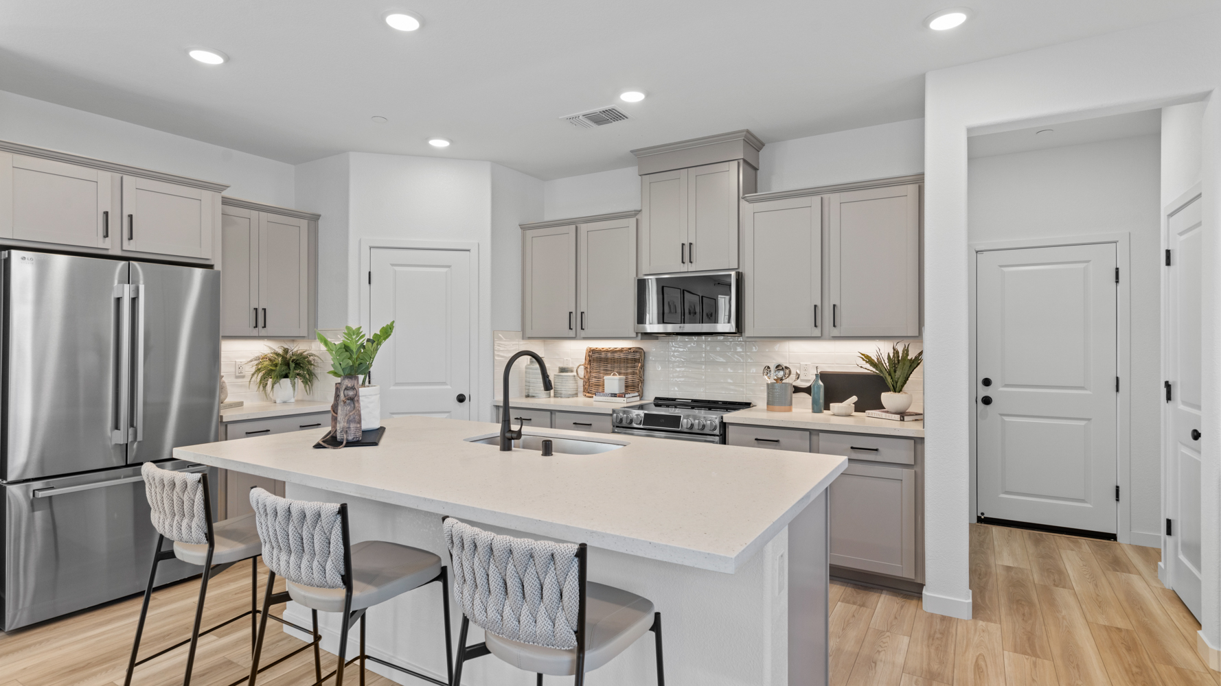 A kitchen with white cabinets.