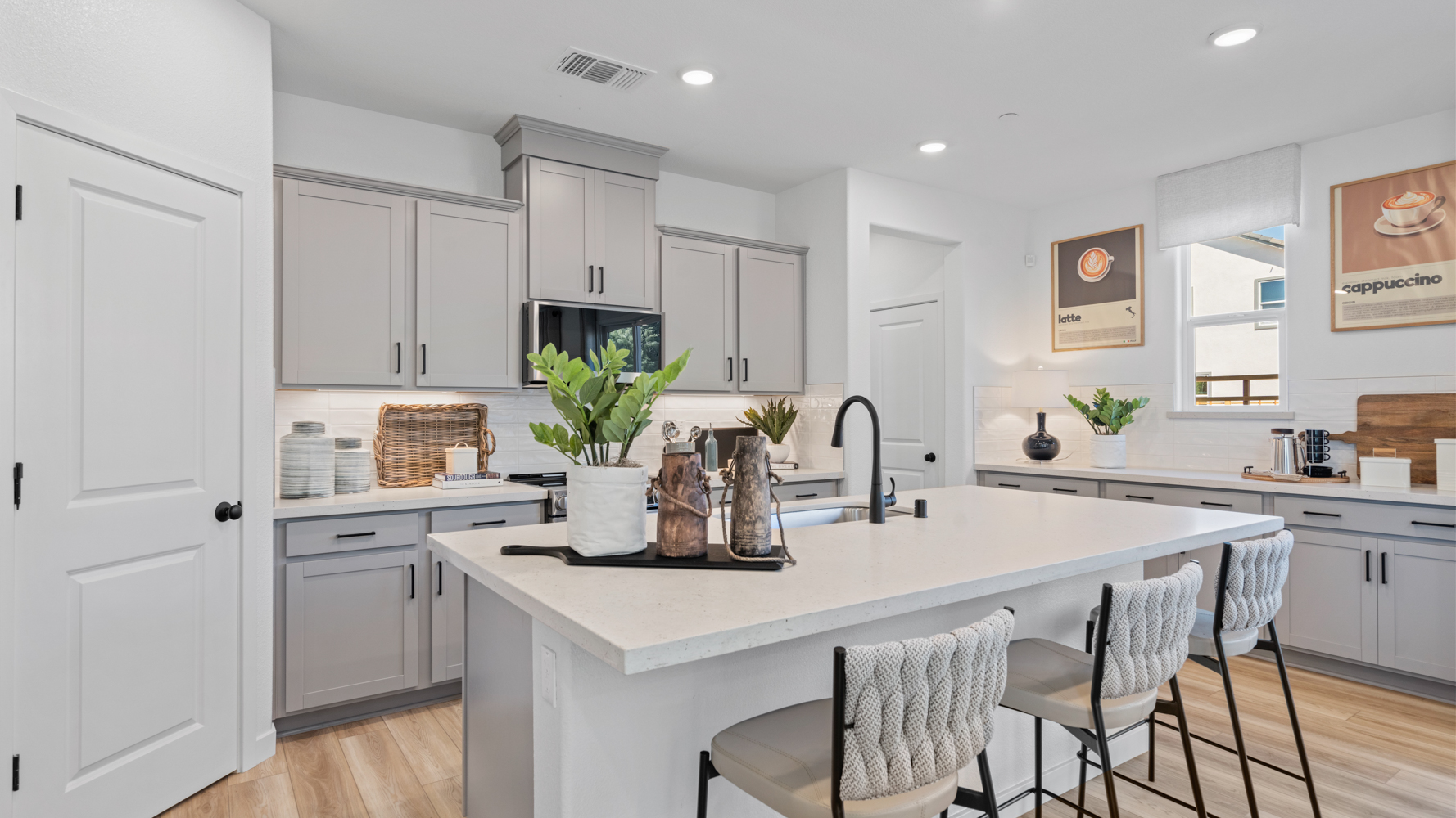 A kitchen with white cabinets.
