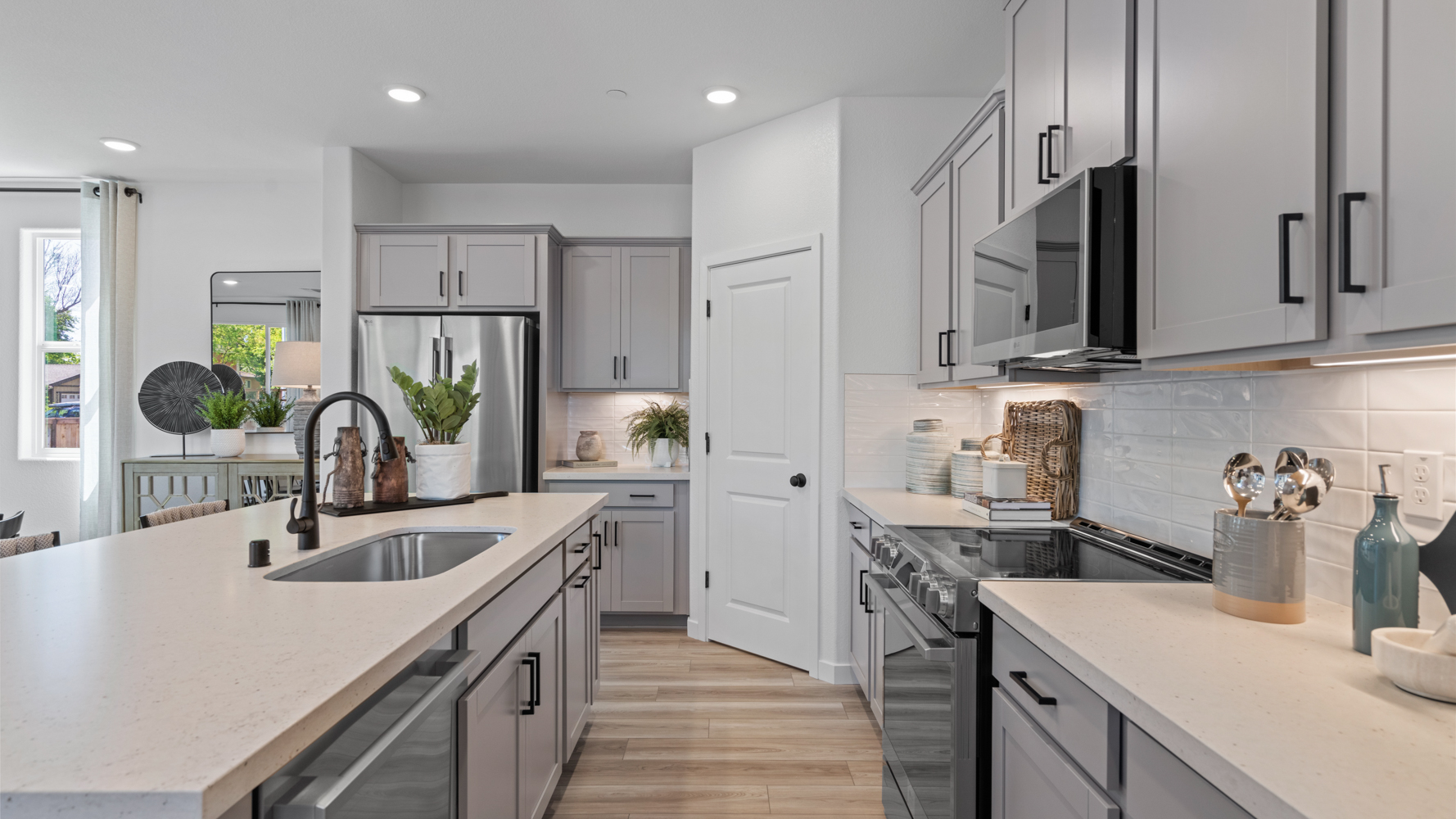 A kitchen with white cabinets.