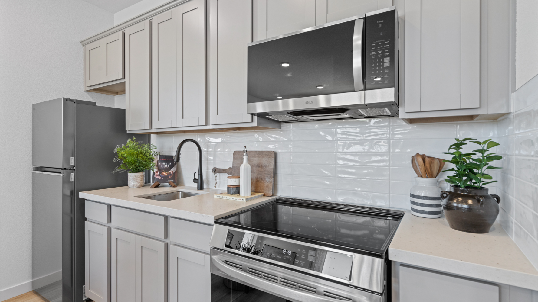 A kitchen with white cabinets.