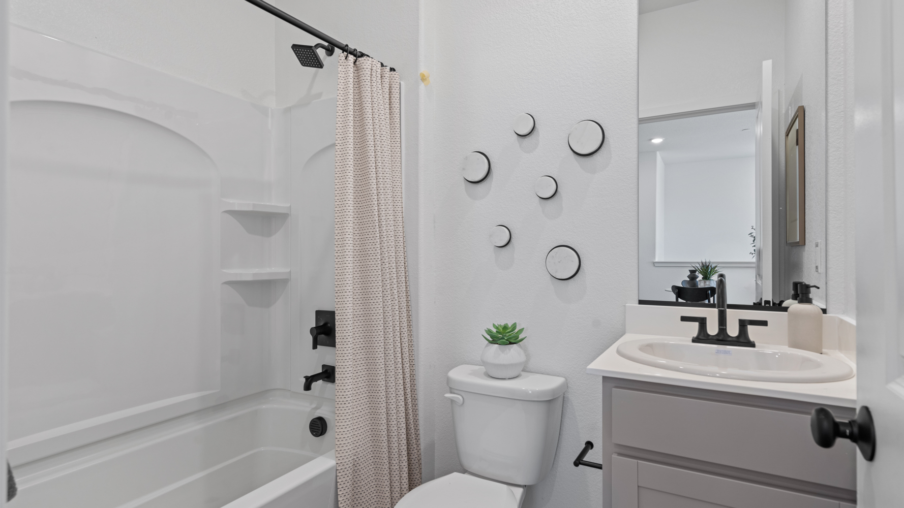 A bathroom with a tub sink and toilet.